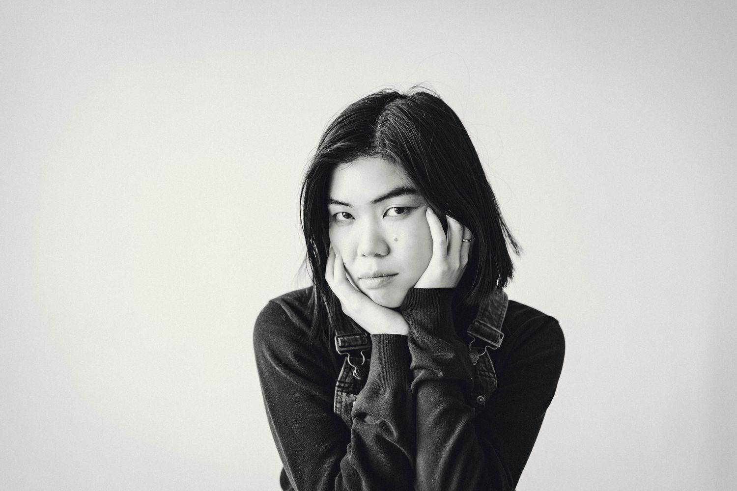 Artistic black and white portrait series against light background.