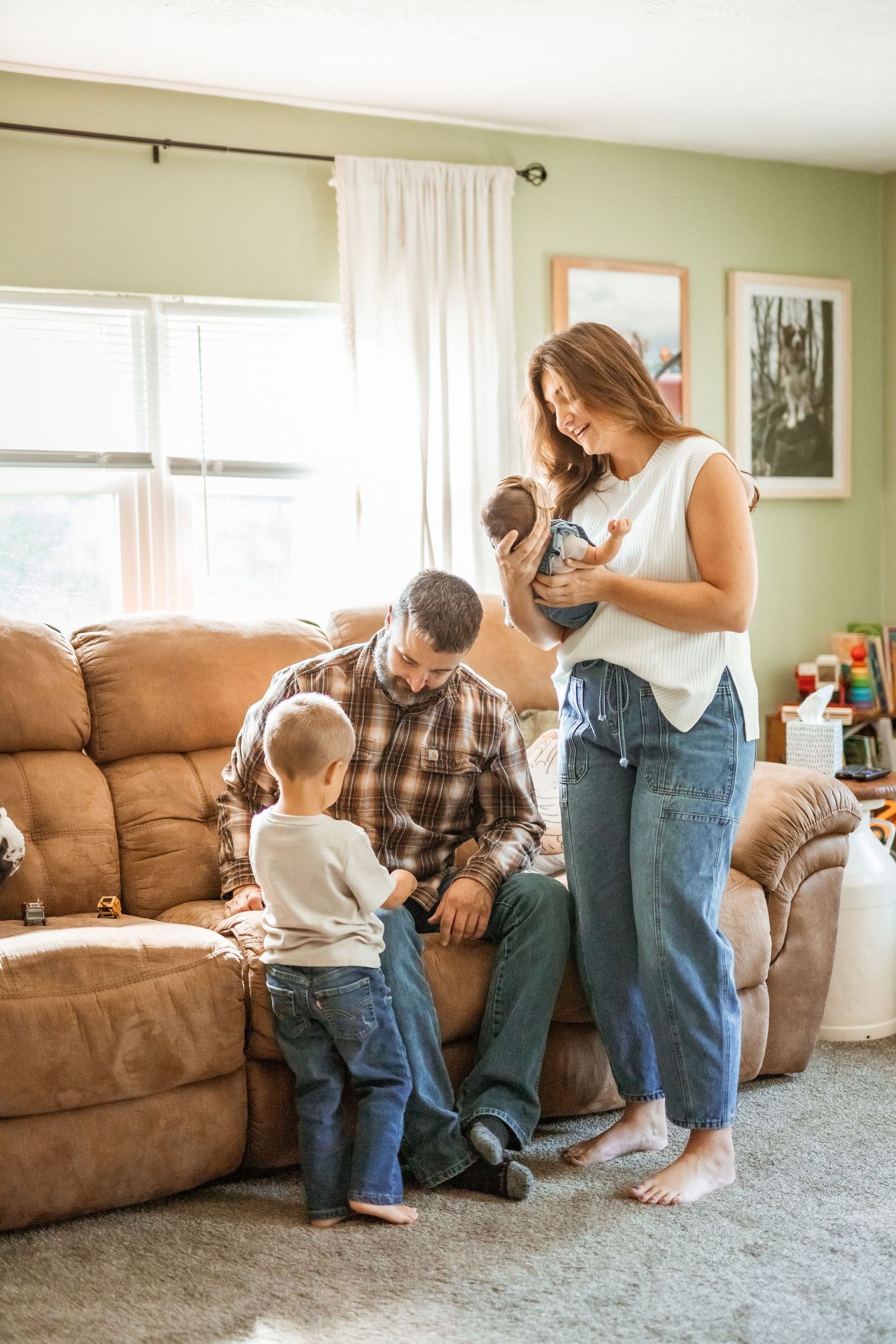 A family shares playful moments together in their living room, captured in a series of candid photographs.
