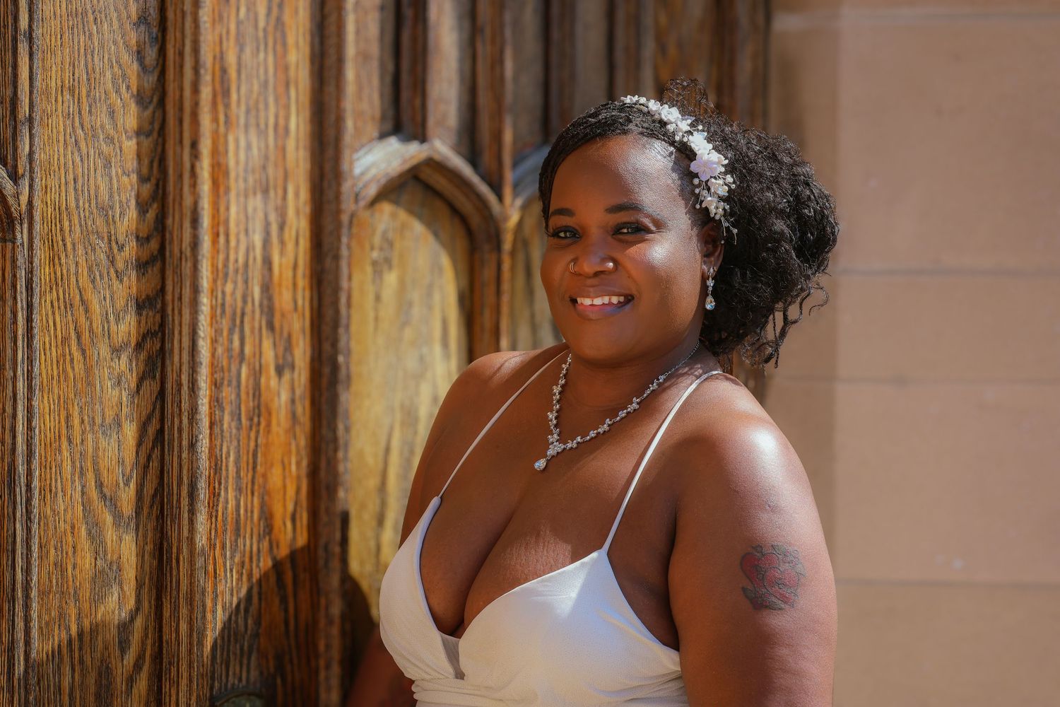 Elegant bridal portrait in white dress with silver jewelry.