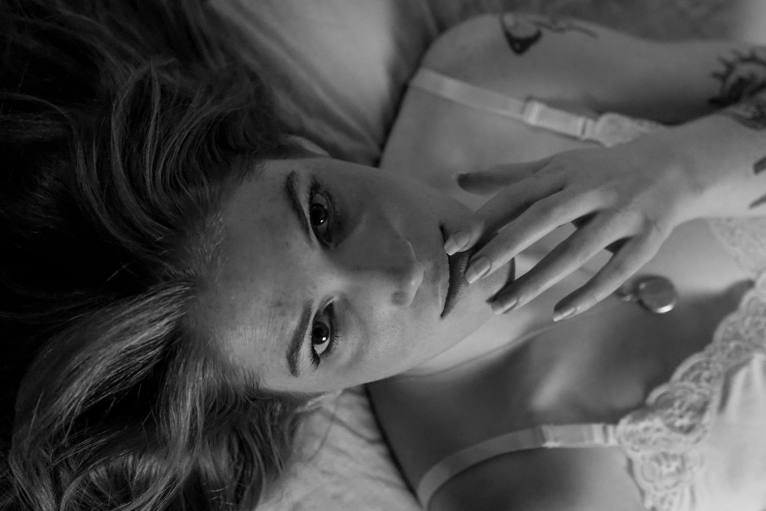 A series of black and white artistic portrait photographs showing dramatic lighting and shadows.