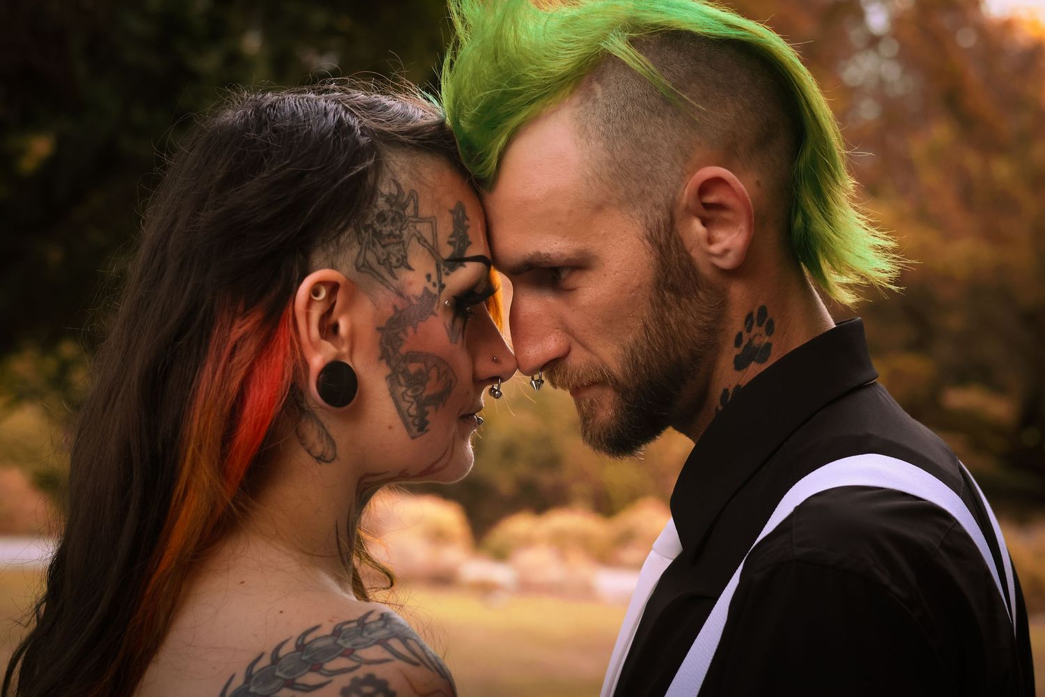A romantic couple shares intimate moments in a series of outdoor autumn portraits with warm golden lighting.
