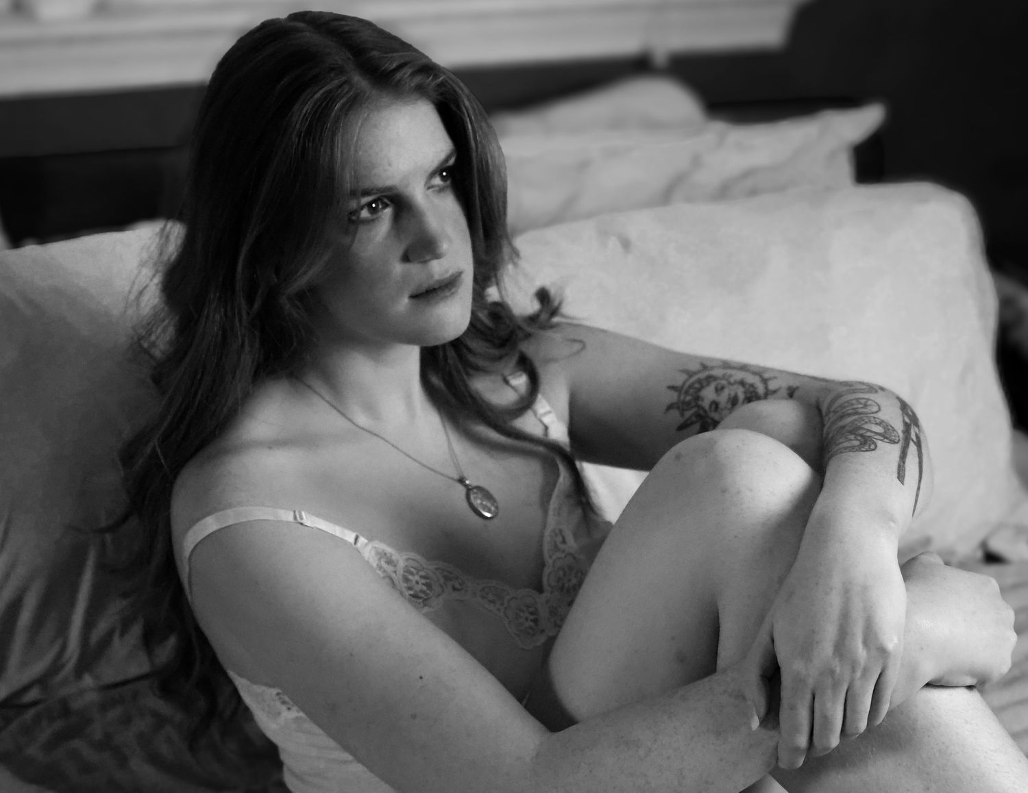 Black and white photo series showing intimate moments between a couple lying together in bed.
