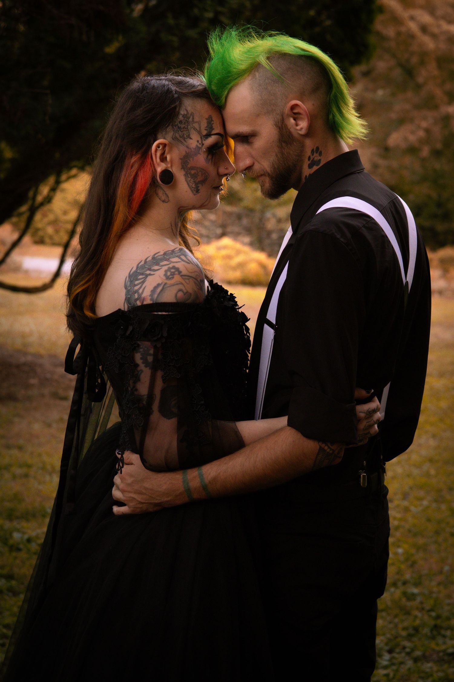 A romantic couple in black attire embraces and kisses outdoors in a series of intimate photos.