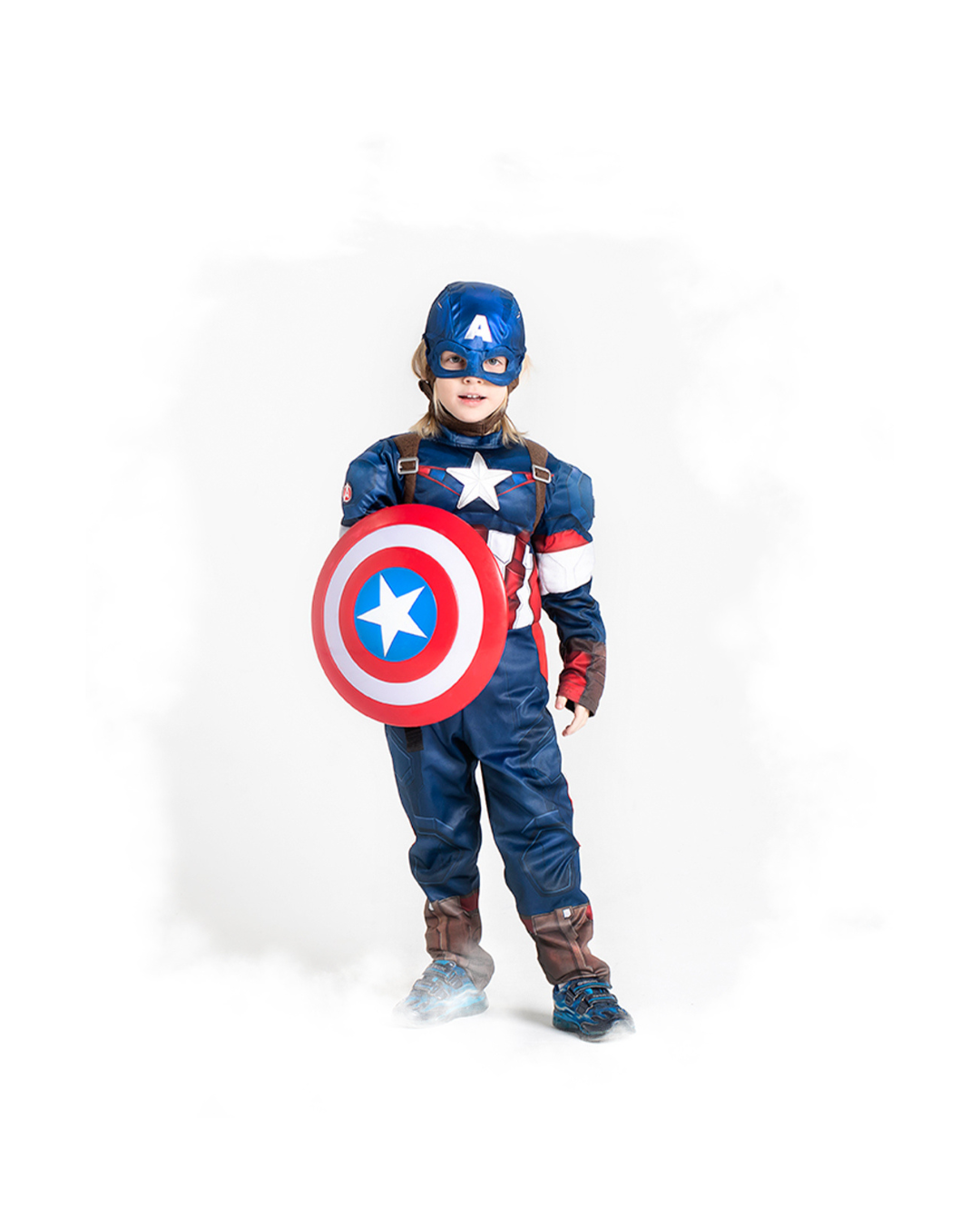 A child wearing a blue Captain America superhero costume with shield and mask poses against a white background.