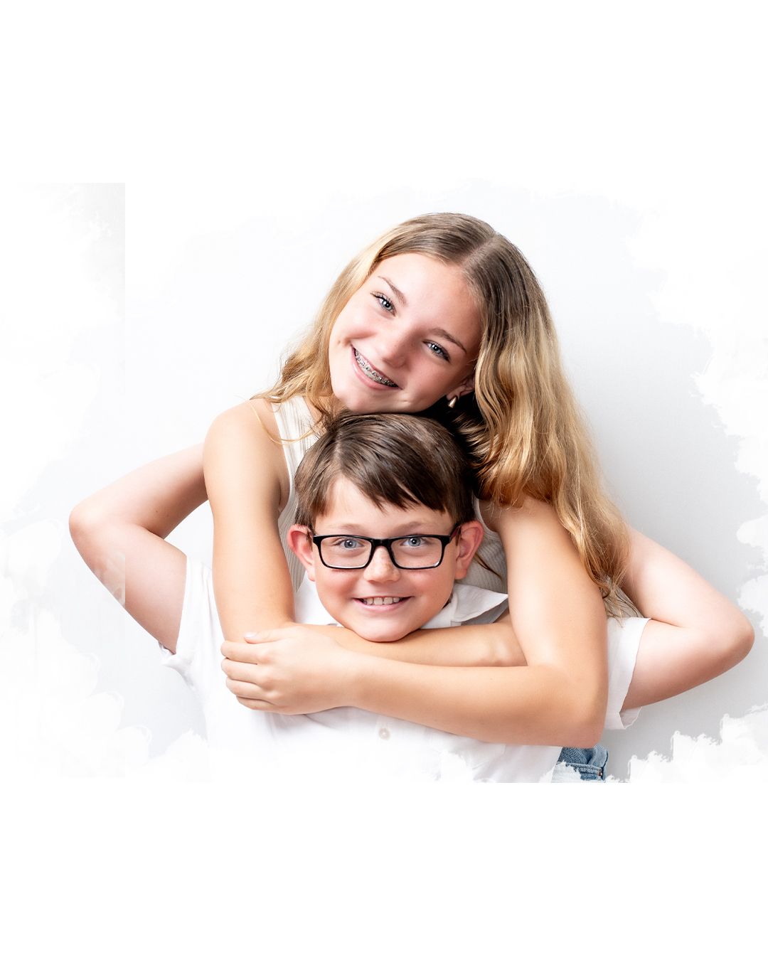 Three joyful expressions shown up close against a white background with warm, natural lighting.