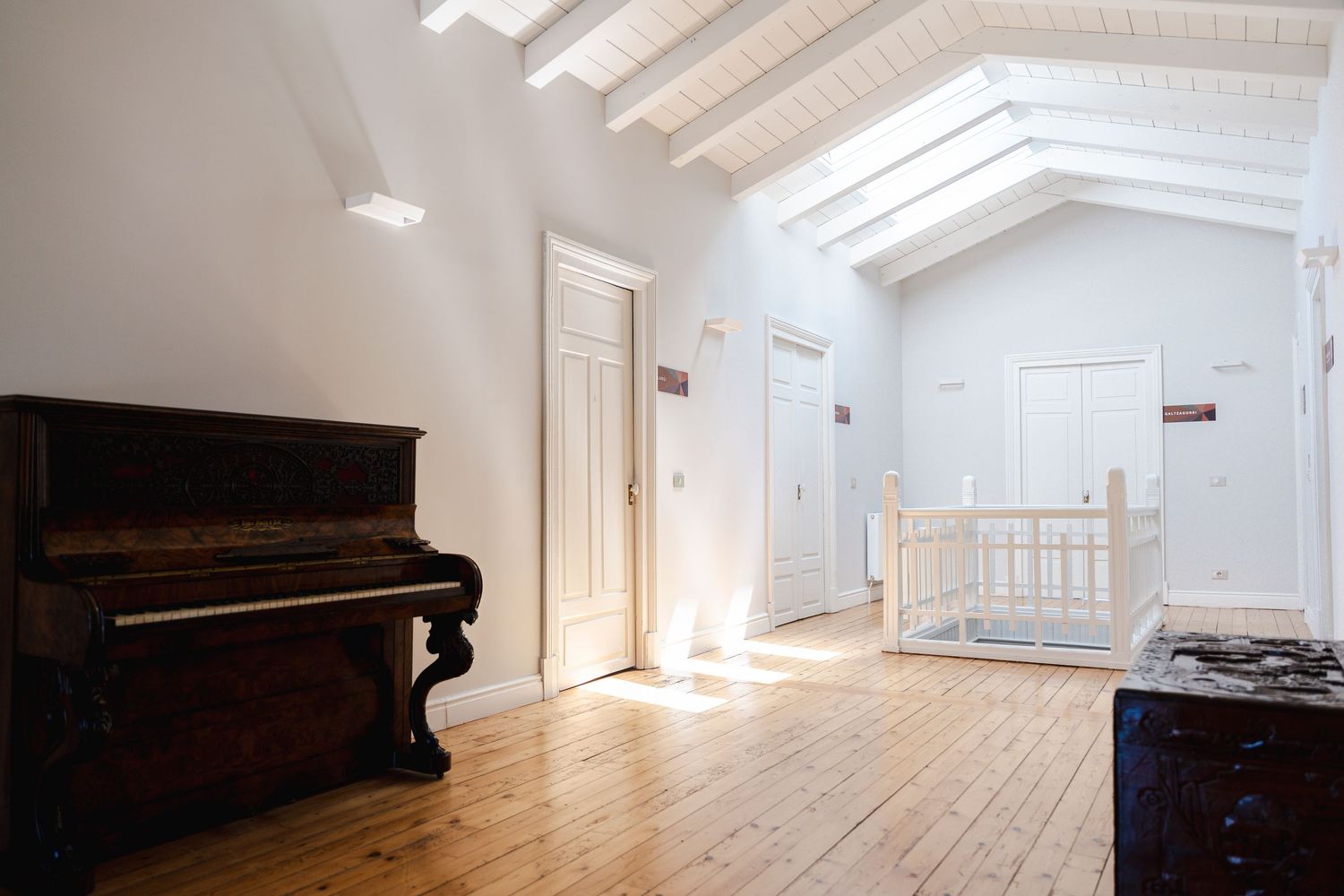 Spacious interior with vaulted ceilings, exposed beams and wide plank hardwood floors.