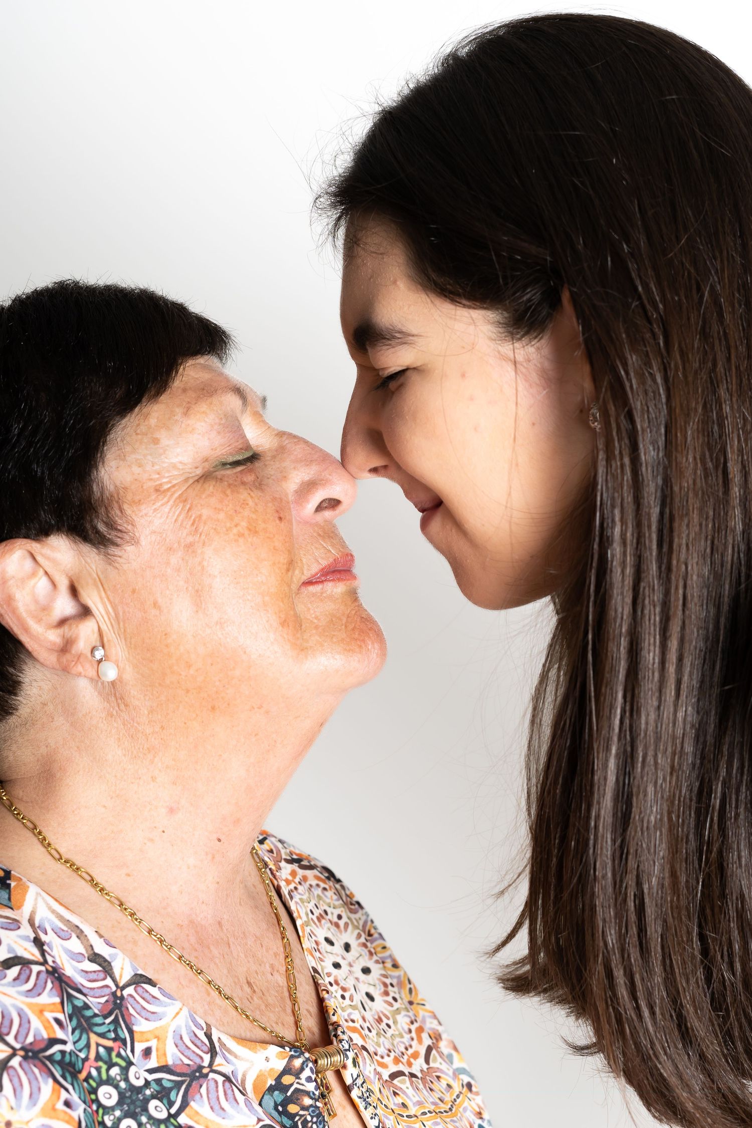 Two people touching noses in an affectionate close-up portrait.
