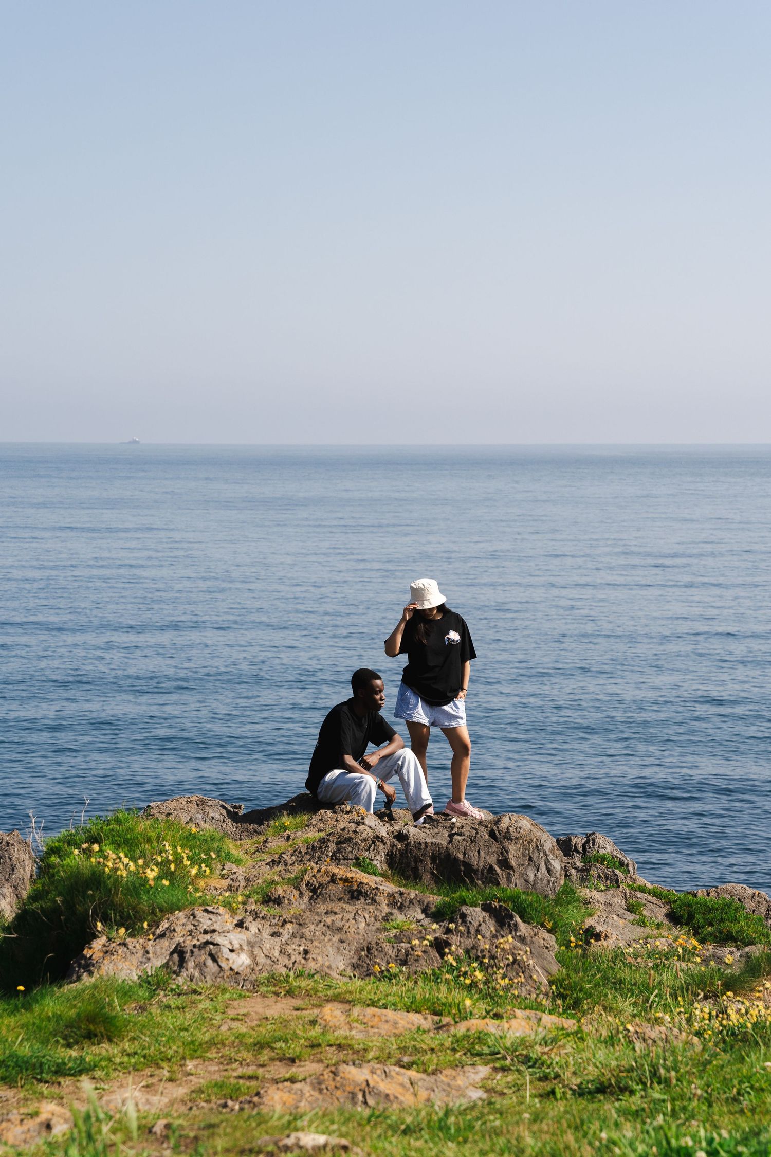 Scenic coastal viewpoint overlooking blue ocean waters on a clear sunny day.