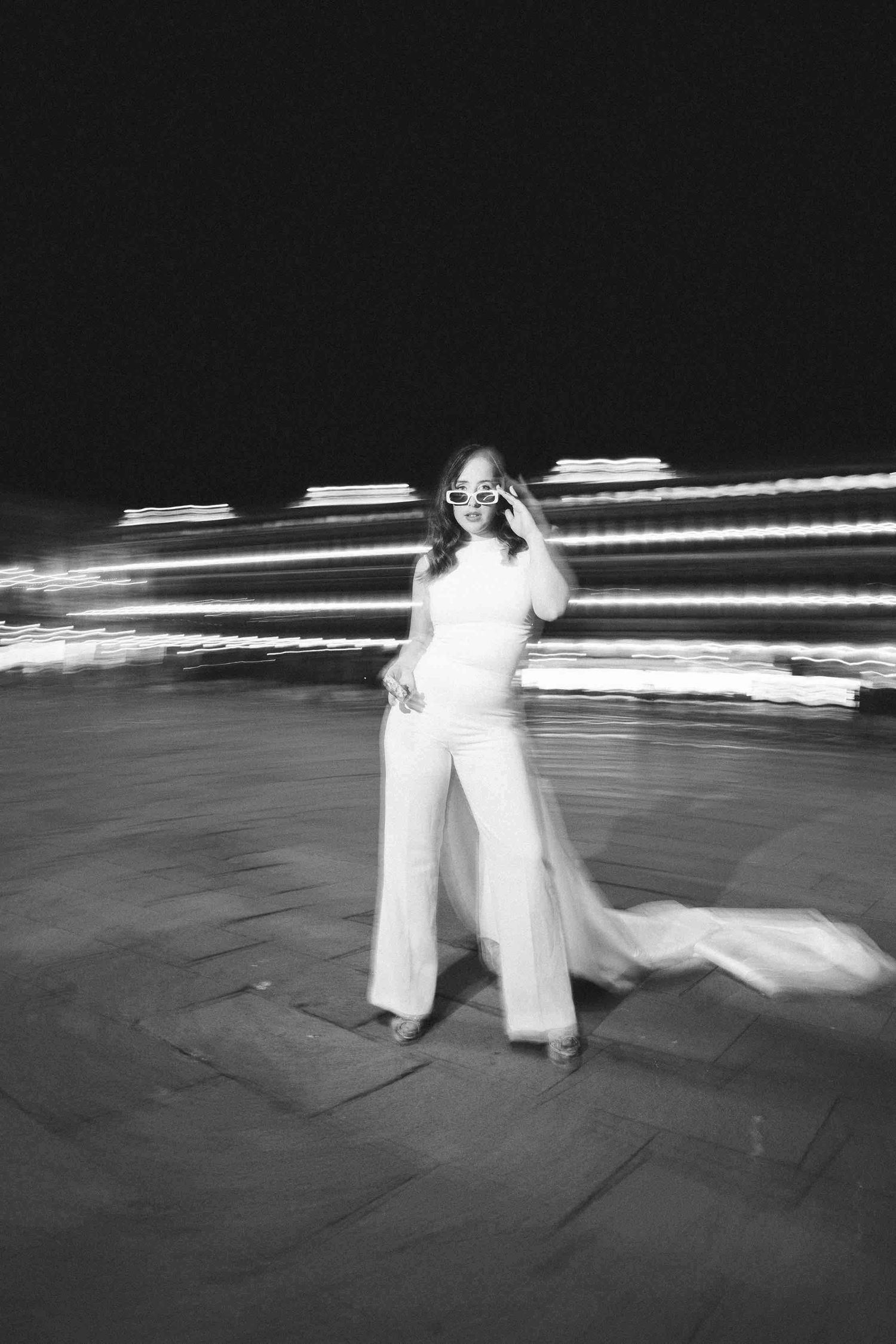 Black and white sequence of flowing movement on dark stage.