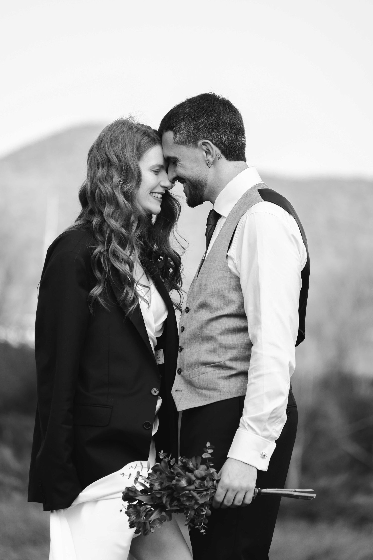 Romantic black and white photo series of a couple sharing intimate moments outdoors.