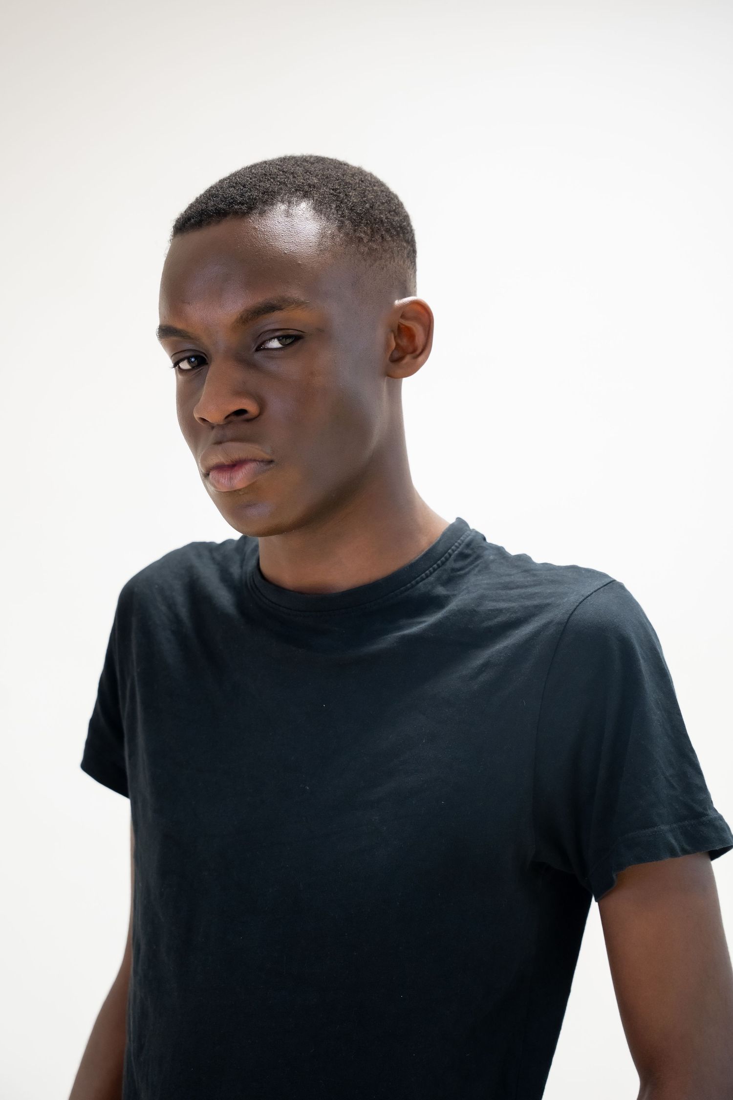 Person in black t-shirt poses against white background.