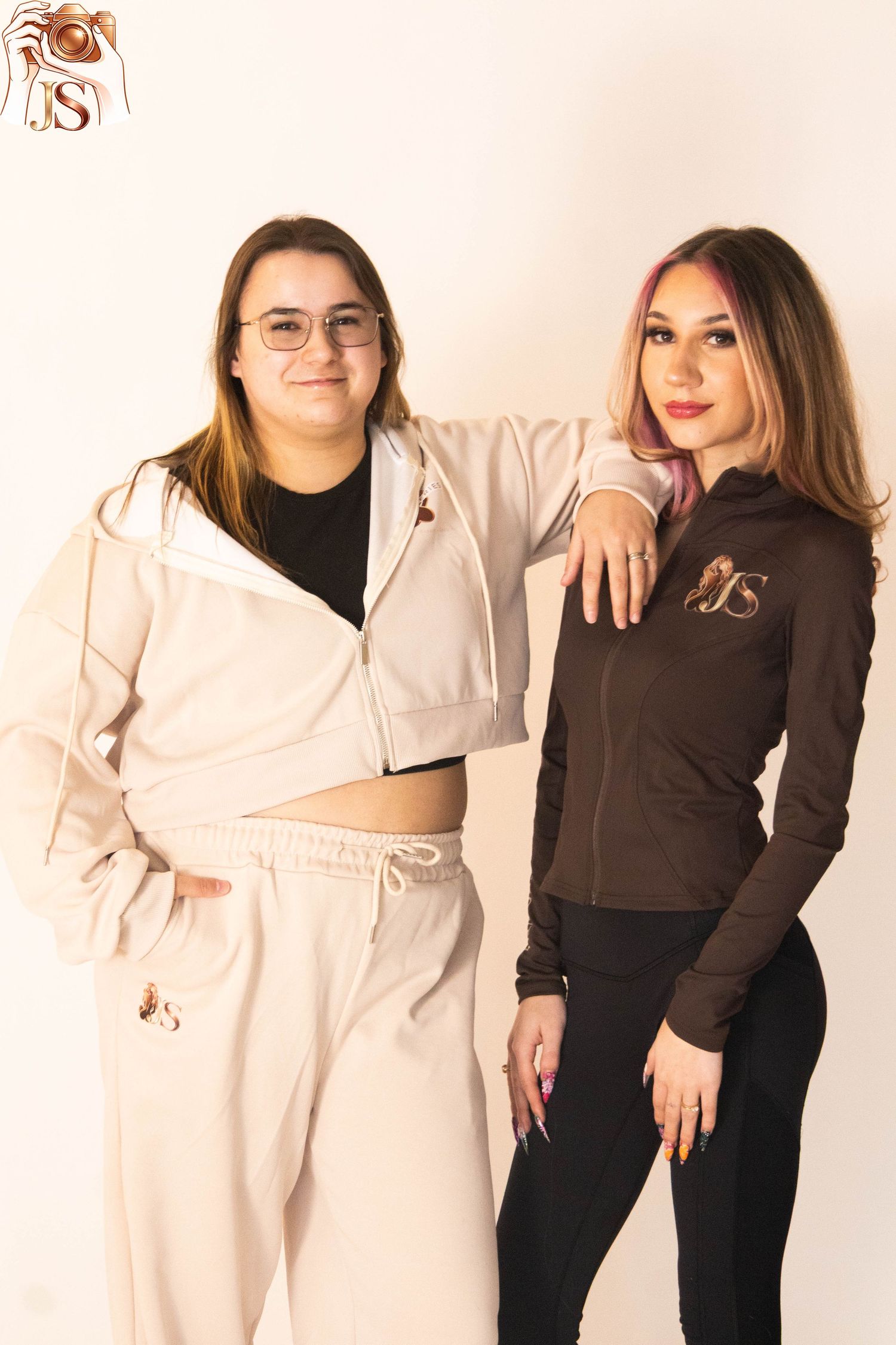 A series of photos showing two people posing together wearing contrasting black and cream colored outfits.