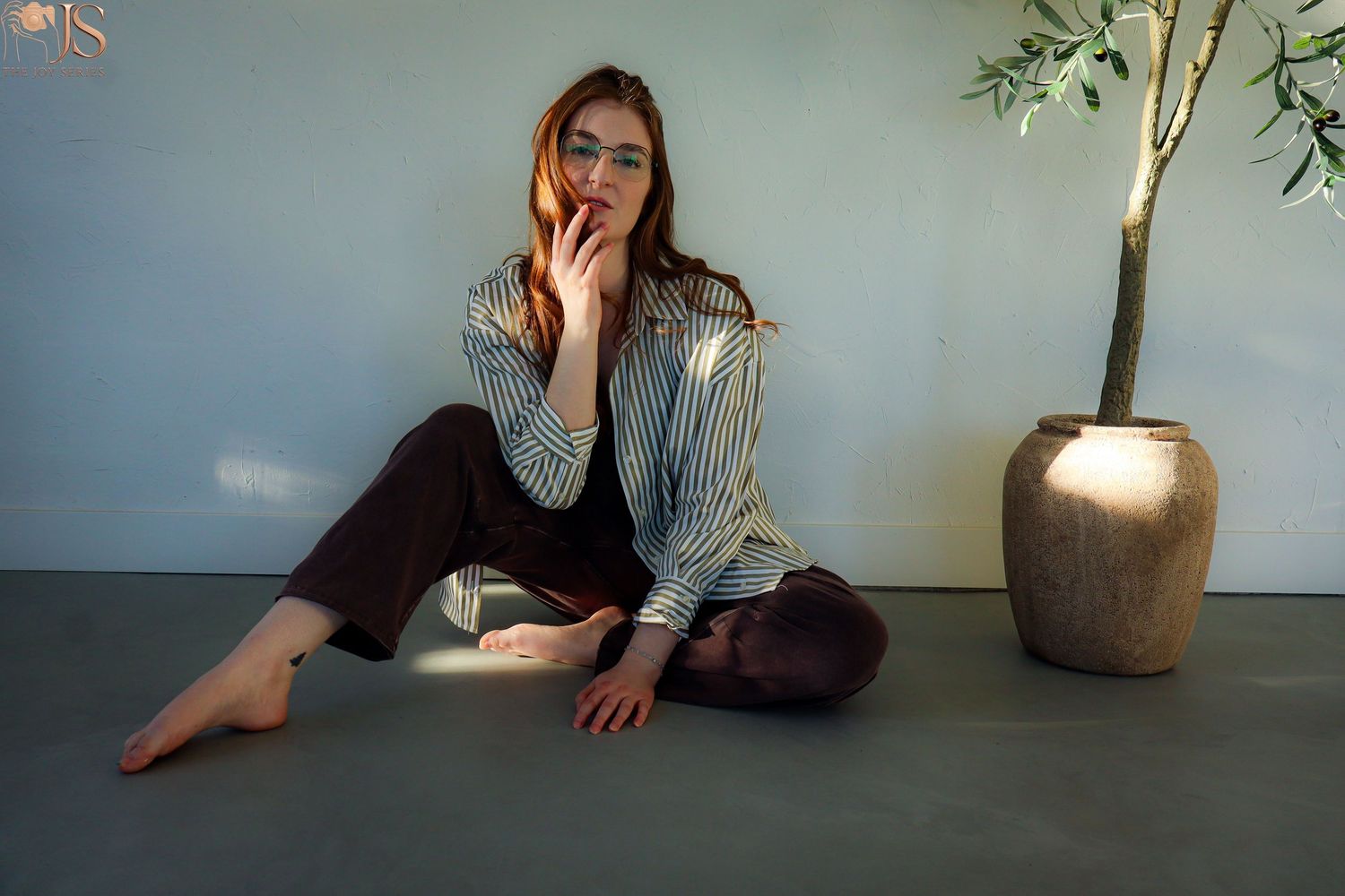 A series of artistic indoor portraits showing a person in casual attire lounging against a white wall with a vase.