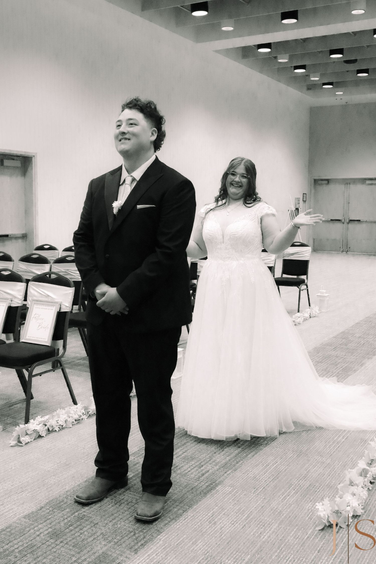 Black and white image series showing a person in formalwear standing near a wedding dress display in an indoor venue.