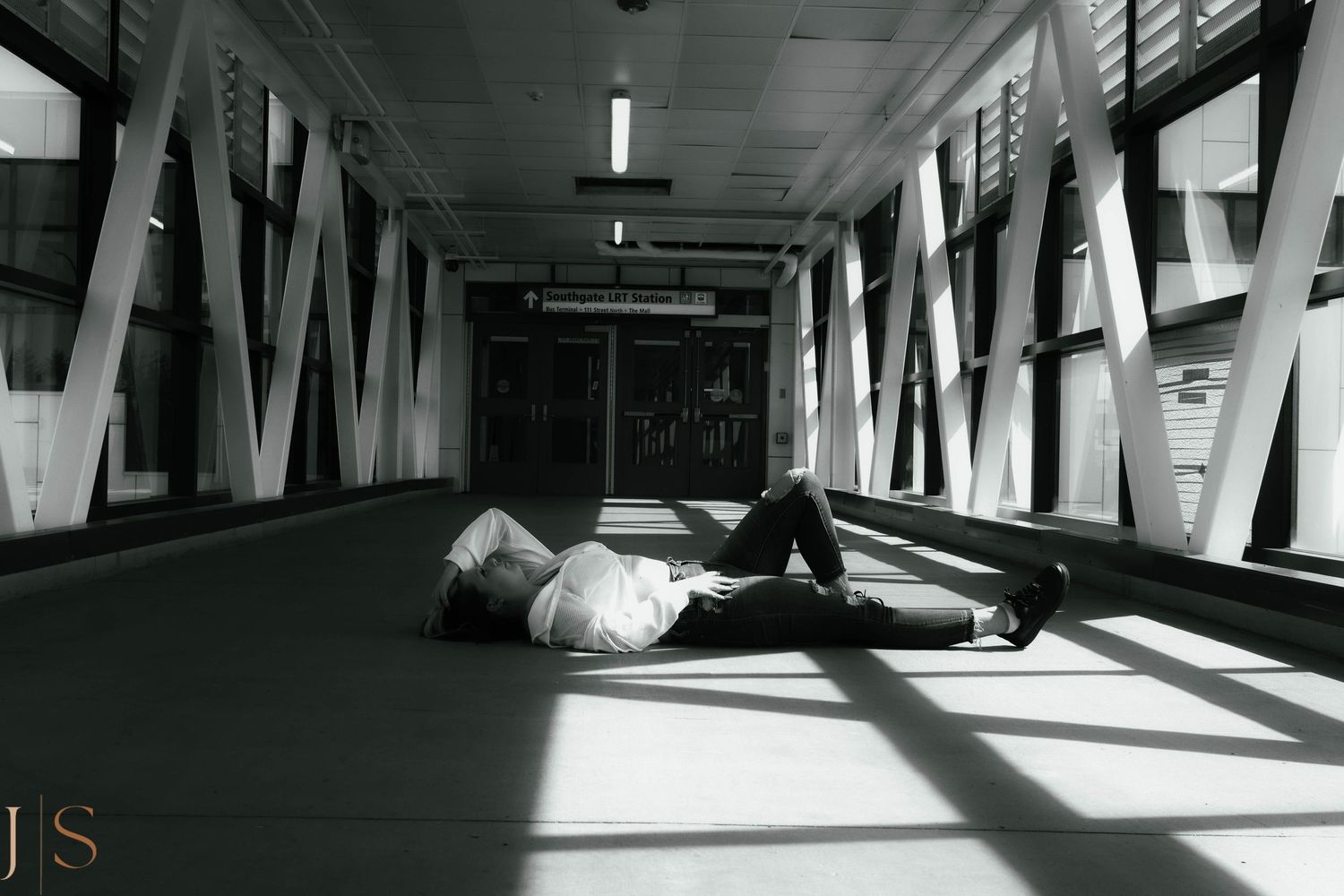 Dramatic black and white architectural interior with strong diagonal lines and shadows created by natural light.