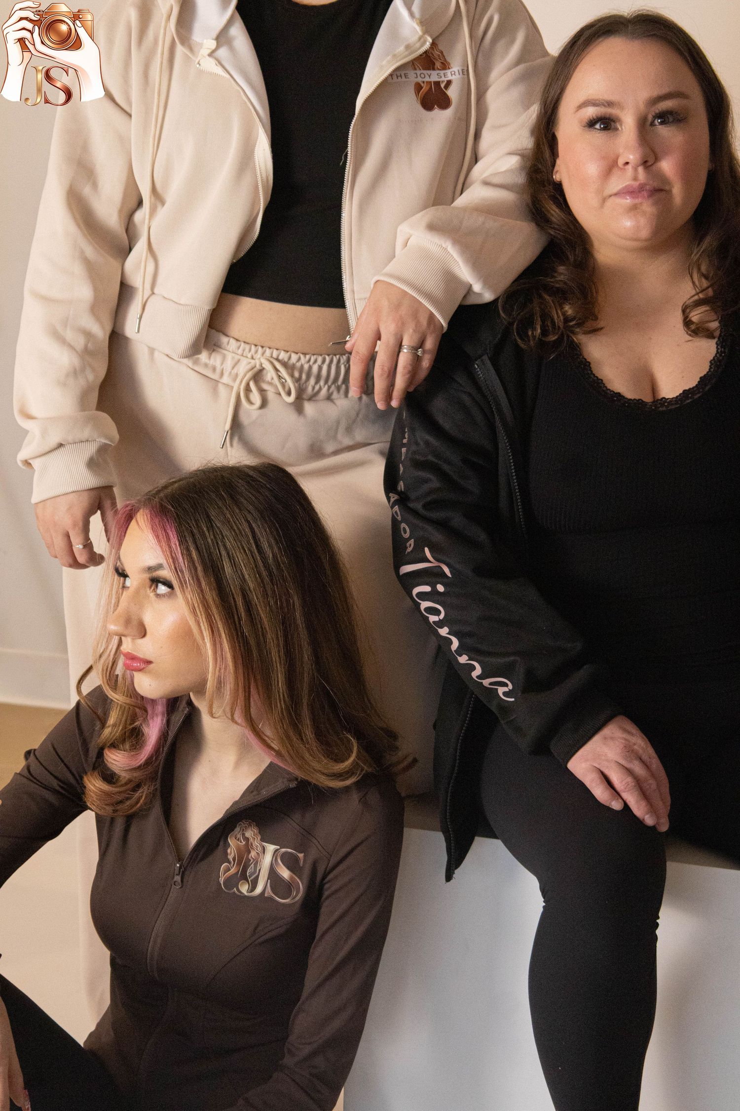 Professional fashion portrait series showing different poses and angles in beige and black clothing against a neutral wall.