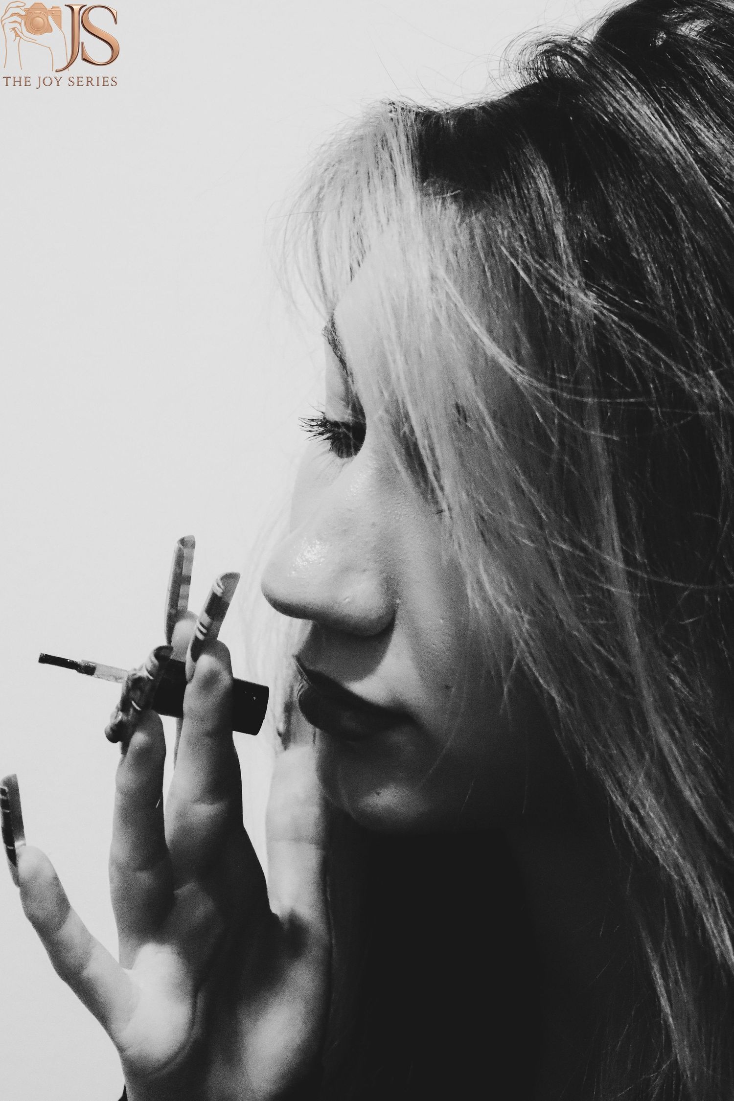 Dramatic black and white profile portrait series with cigarette smoke.