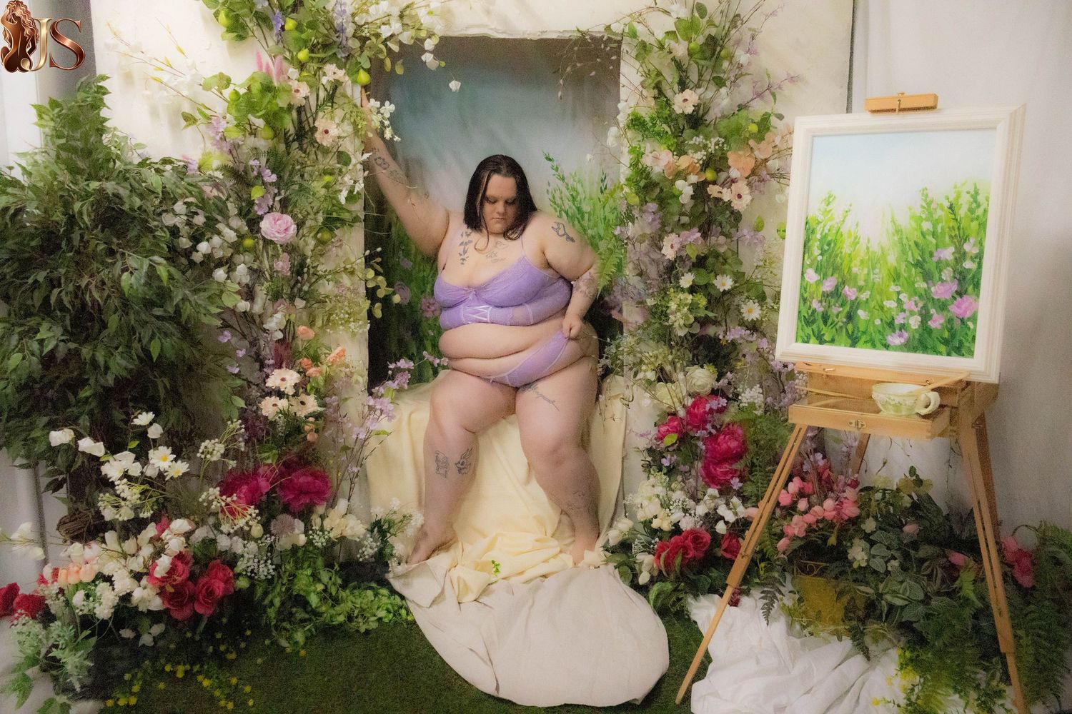 A romantic garden photoshoot featuring floral arrangements, climbing vines, and elegant poses against a natural backdrop.