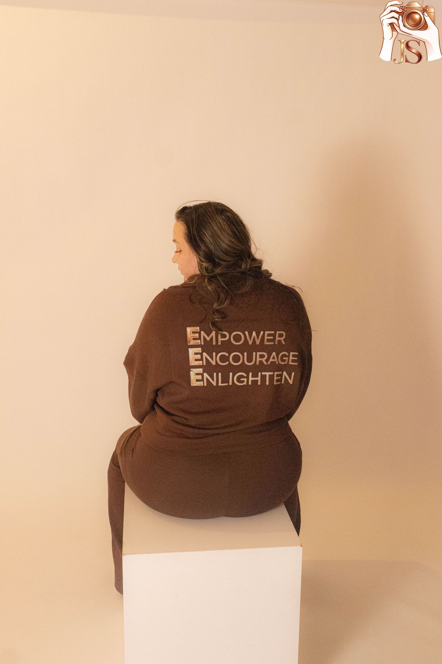 Brown bucket hat with embroidered text 'Empower Encourage Enlighten' shown from multiple angles against beige background.