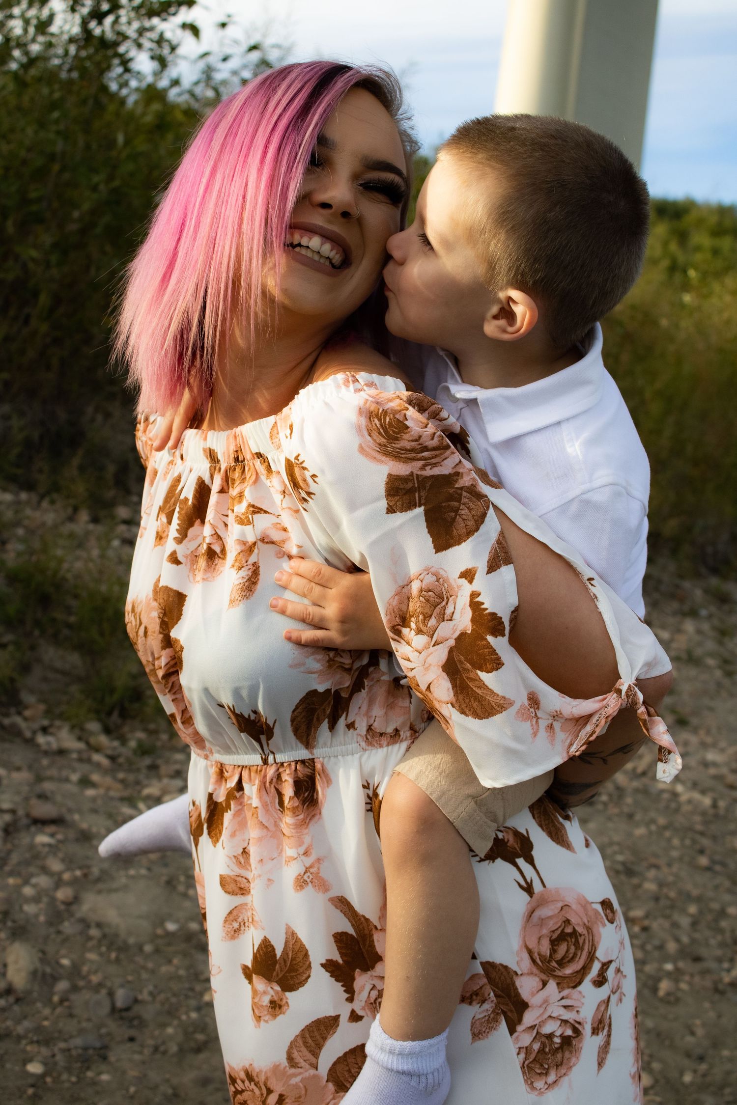 Joyful moment between parent and child wearing matching floral outfits.