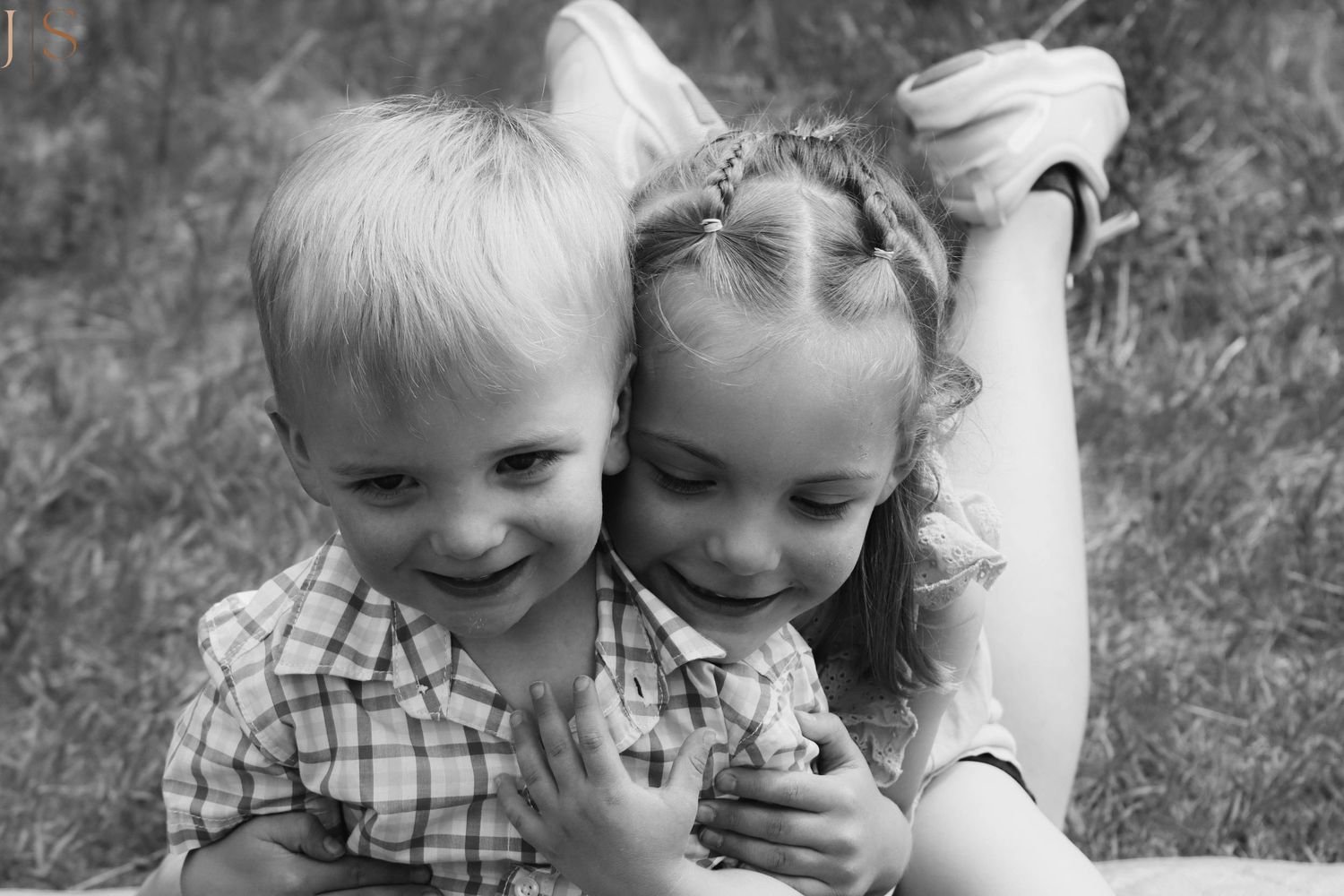 Series of black and white candid photos showing children laughing and playing together outdoors.