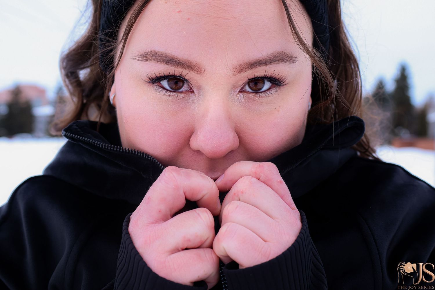 Close up portrait sequence showing someone covering their face while wearing dark clothing.
