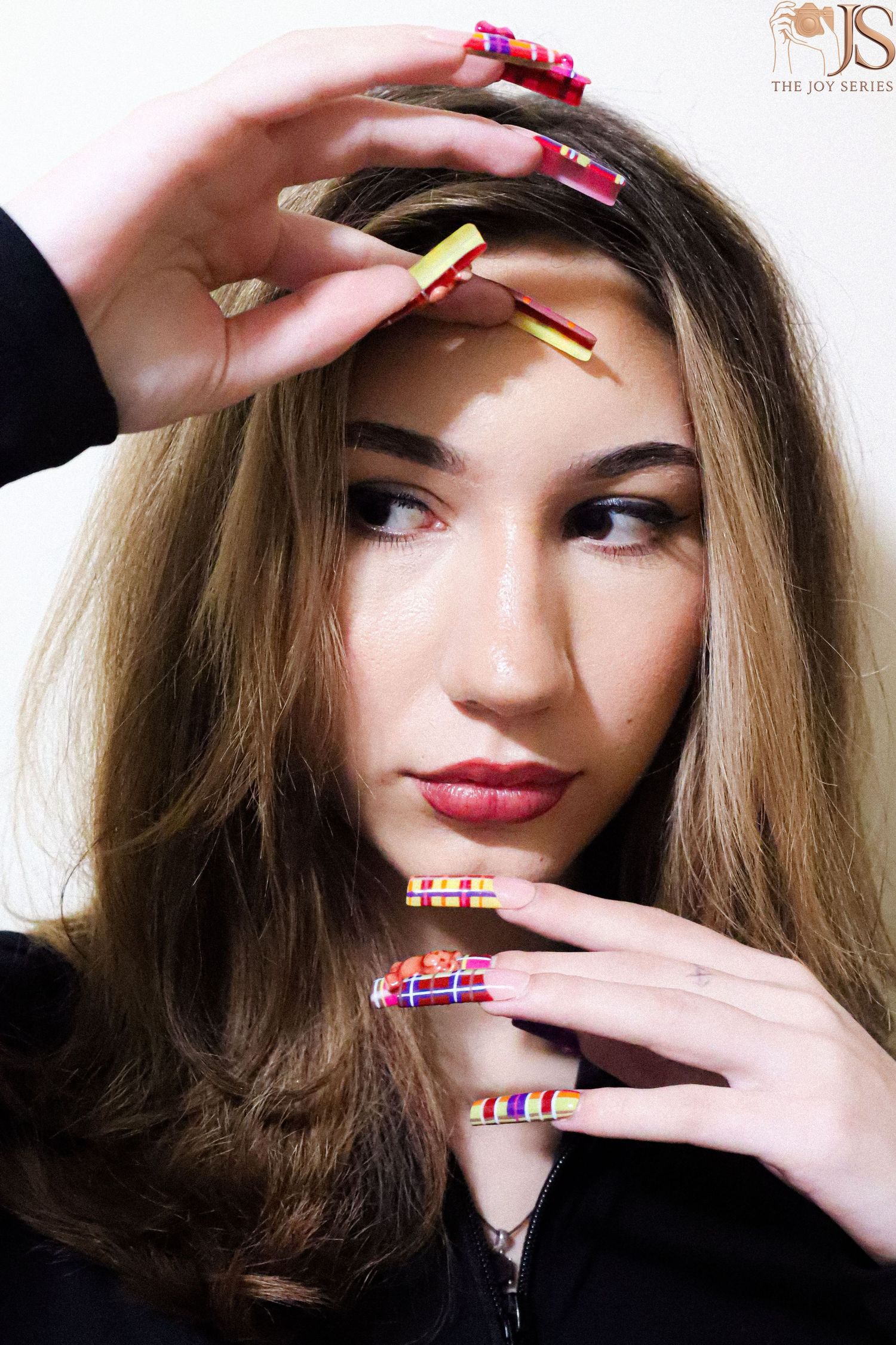 Beauty portrait series showing colorful nails and playful hand gestures.