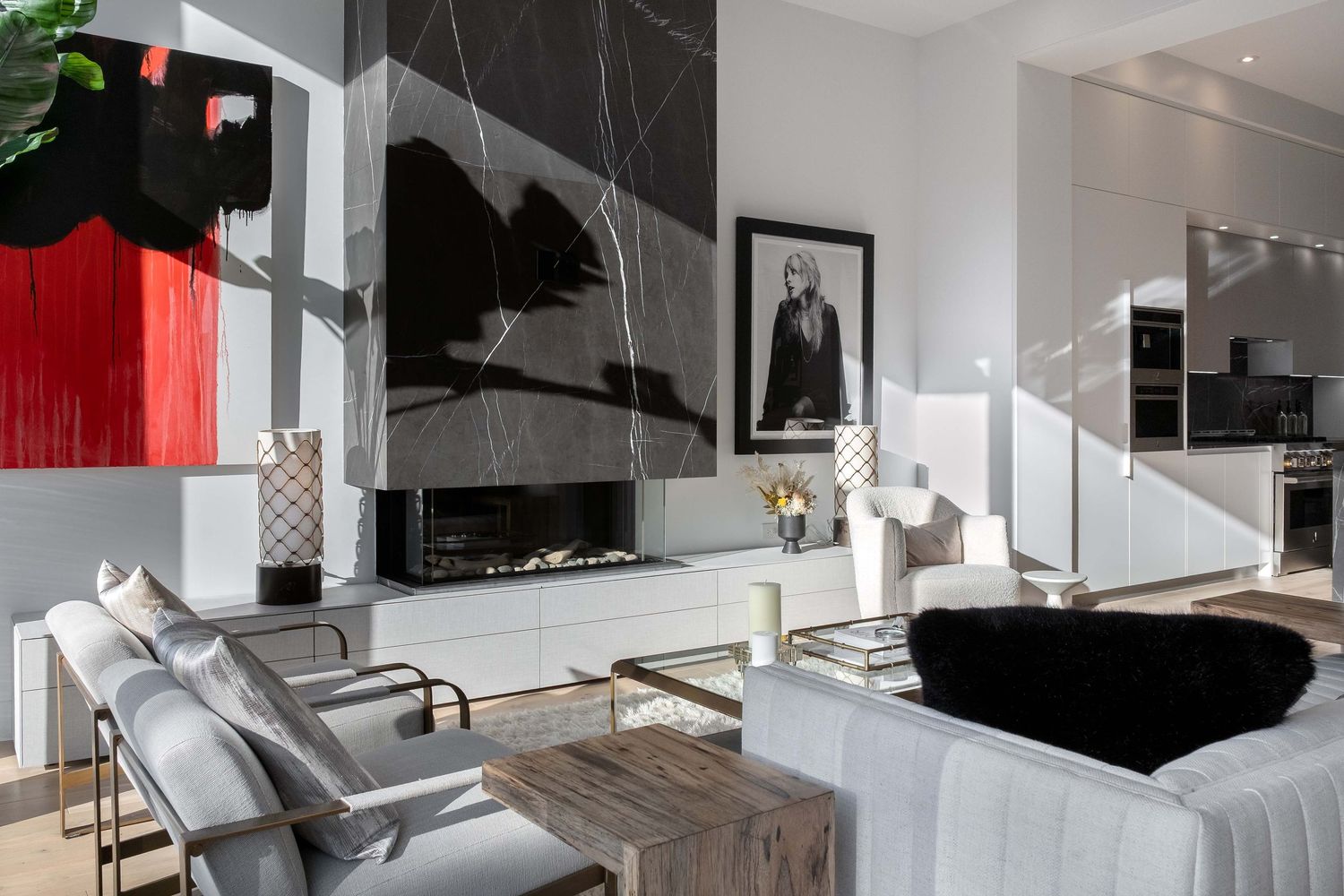 Modern minimalist apartment interior with white walls, gray furniture, and sleek architectural details.