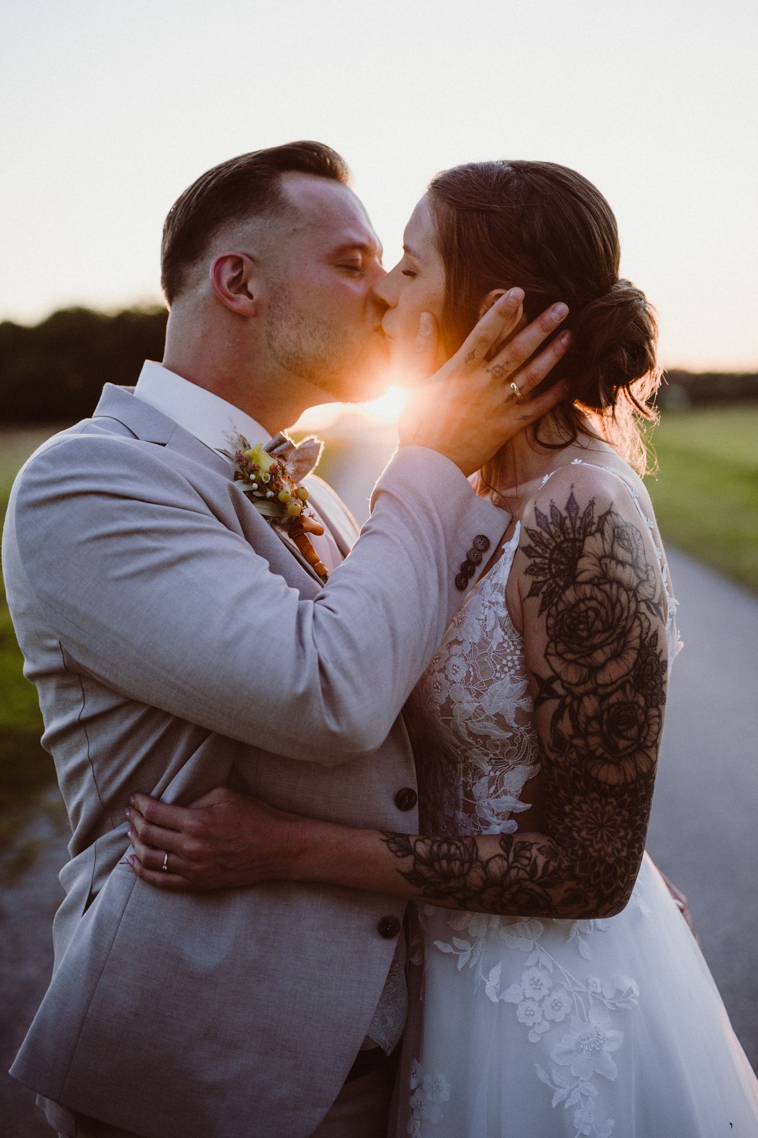 A romantic wedding photo series shows a couple sharing intimate kisses at sunset in an outdoor setting.