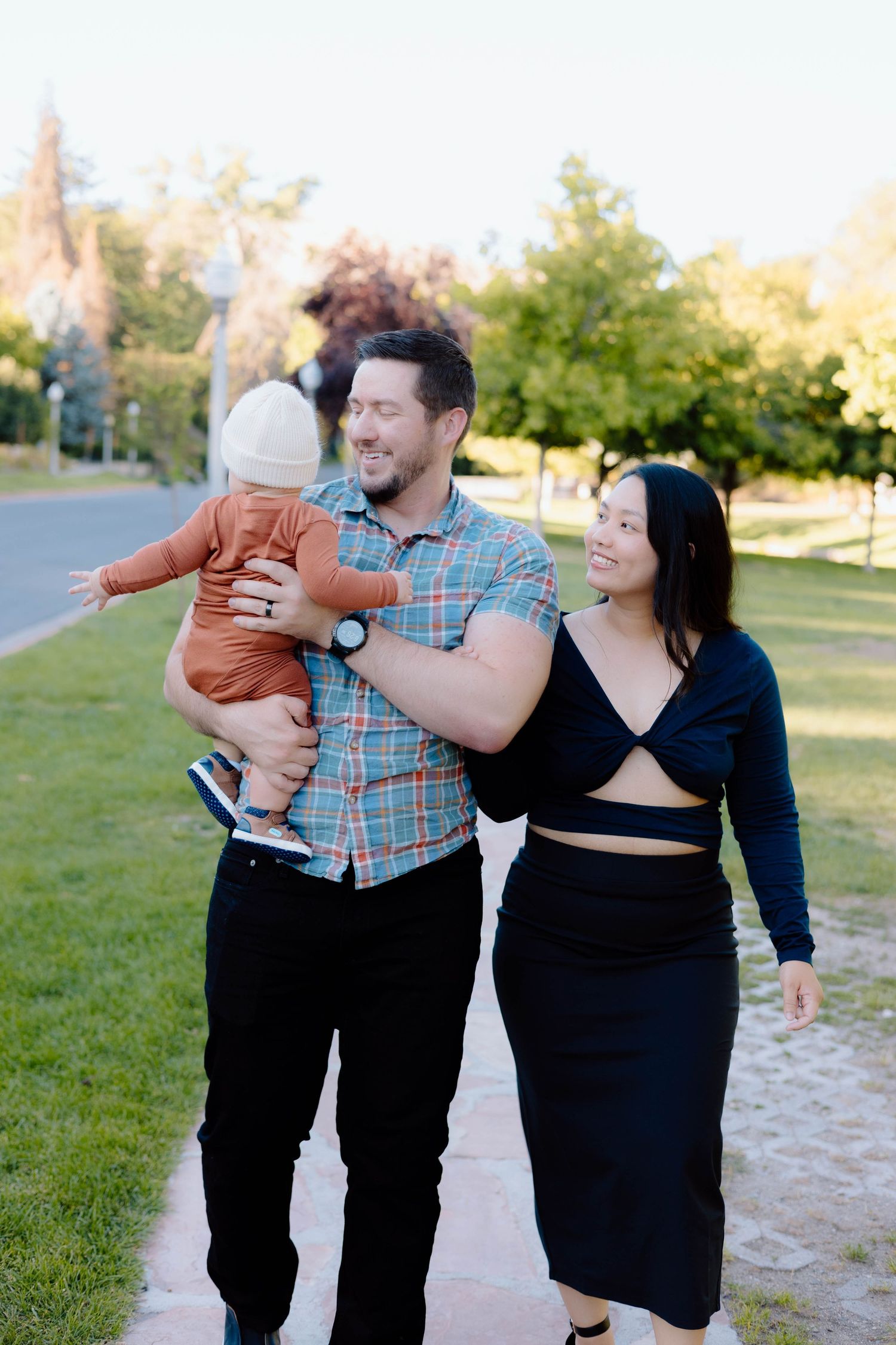 Candid family photo session in a park during golden hour.