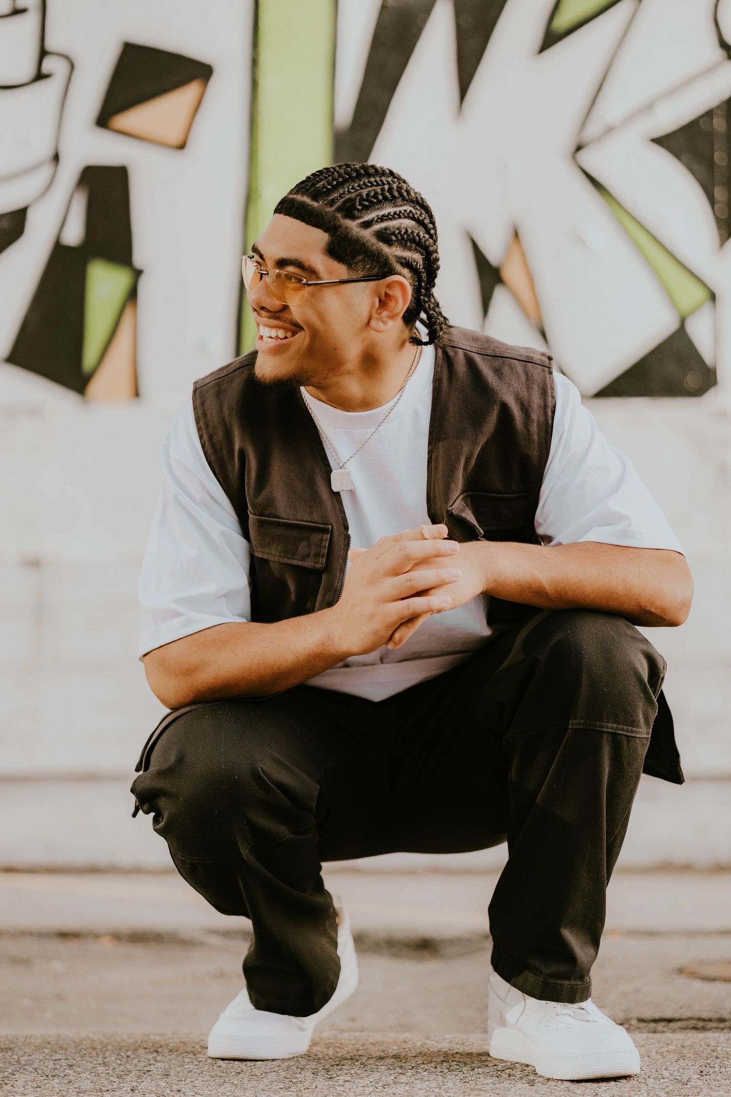 Urban fashion photoshoot featuring casual streetwear and relaxed poses against a geometric wall.