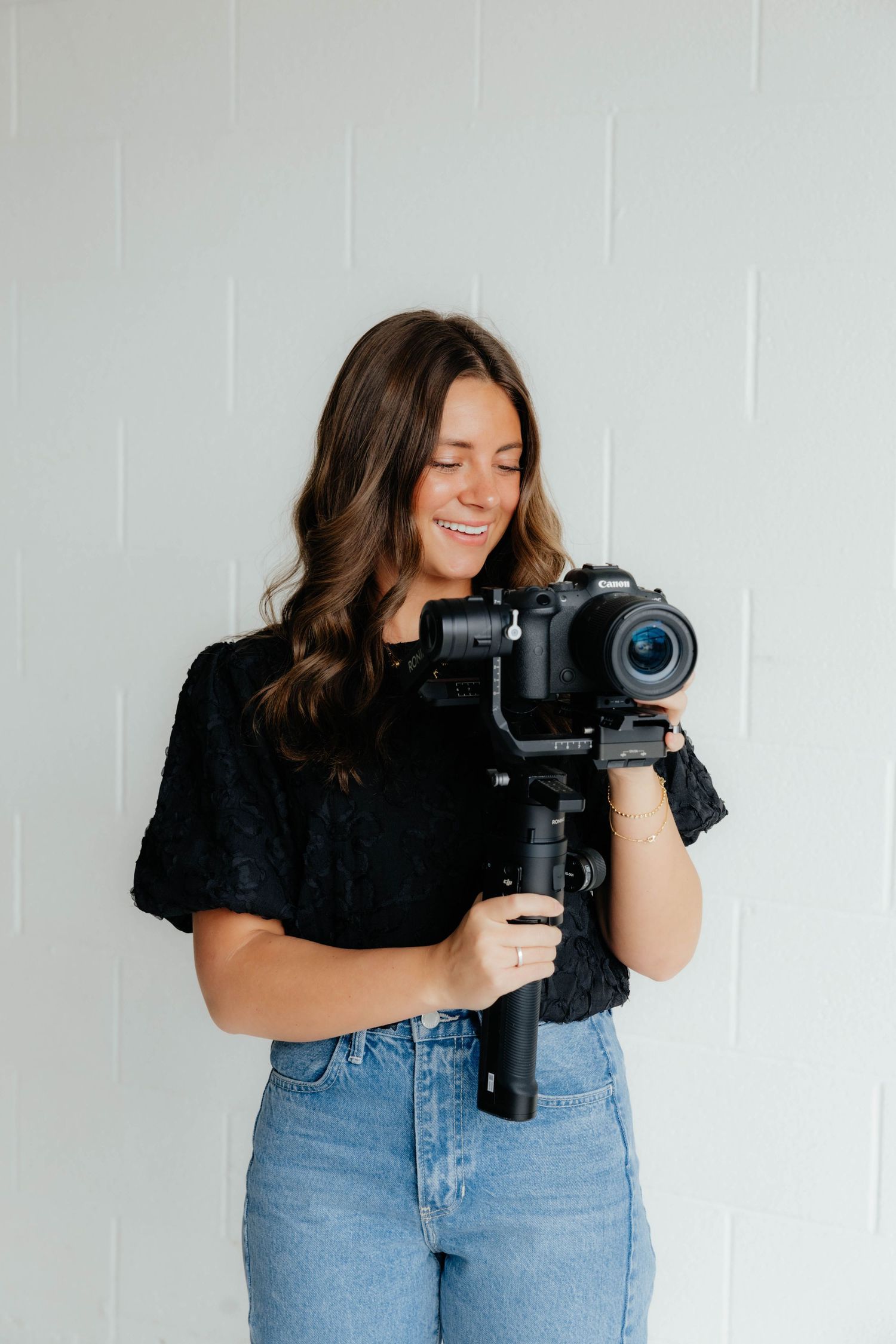 Creative photography session showing someone operating a professional camera in casual attire.