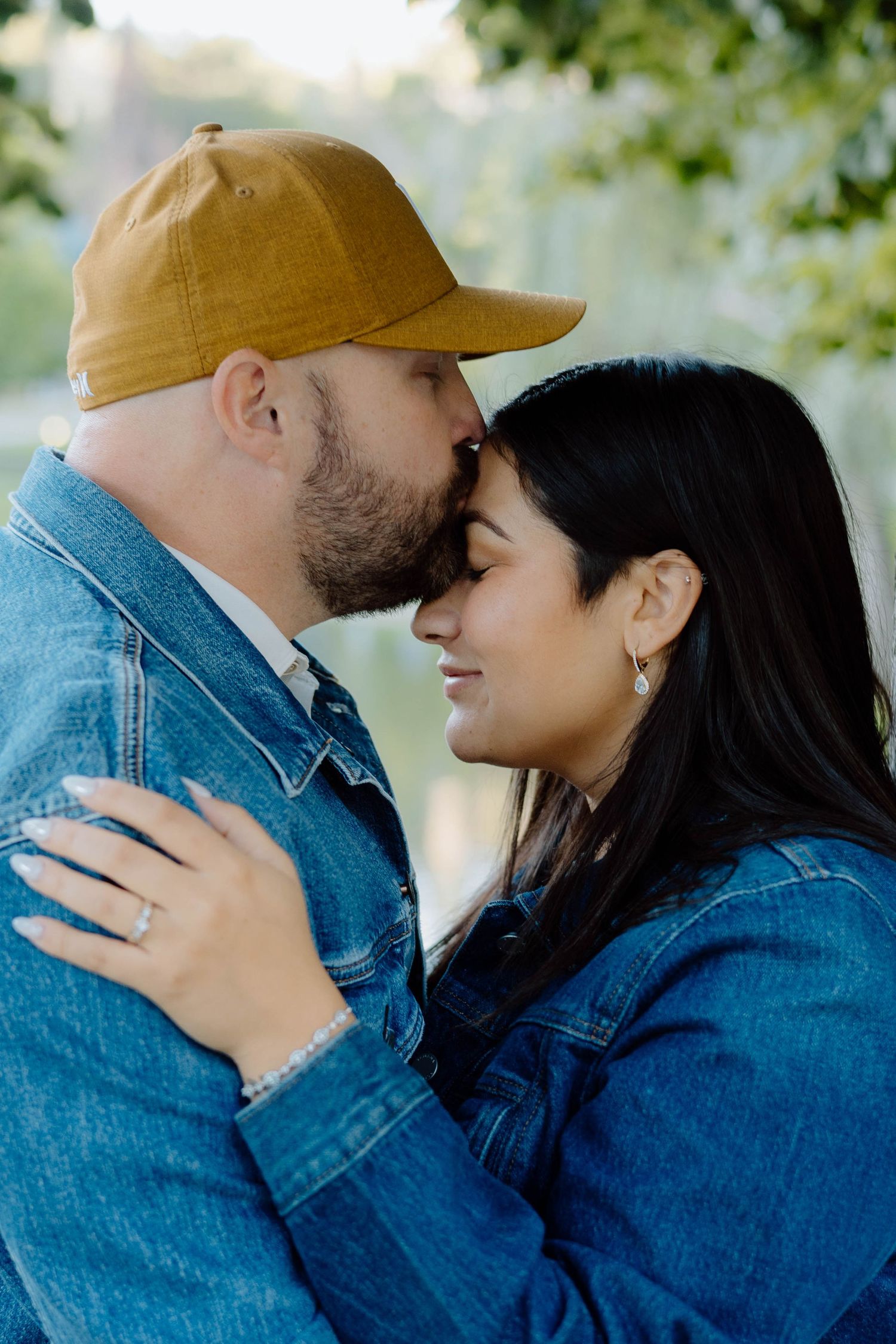 Romantic couple in denim embracing in a tender moment outdoors.