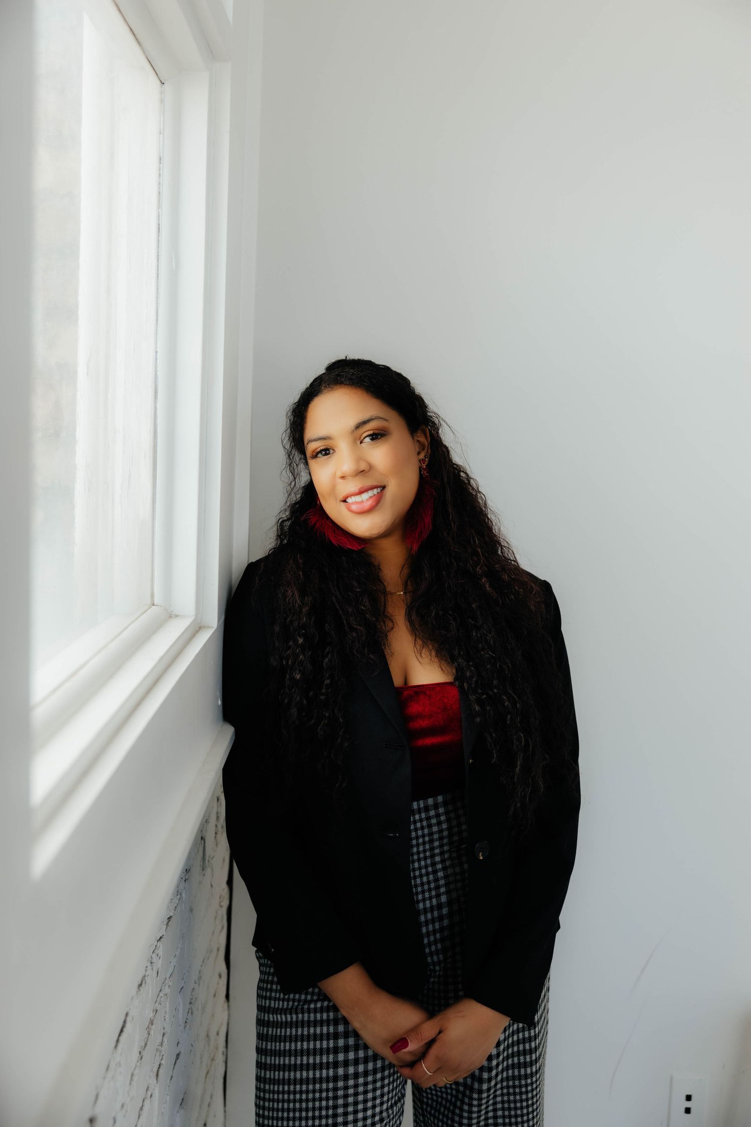 Portrait session against a white wall showing joyful expressions and poses.