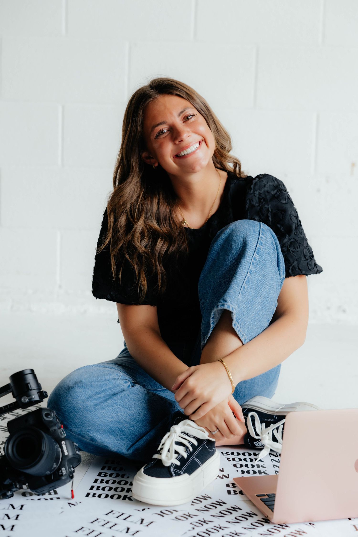 Casual photography session showing relaxed poses with camera equipment on patterned floor.