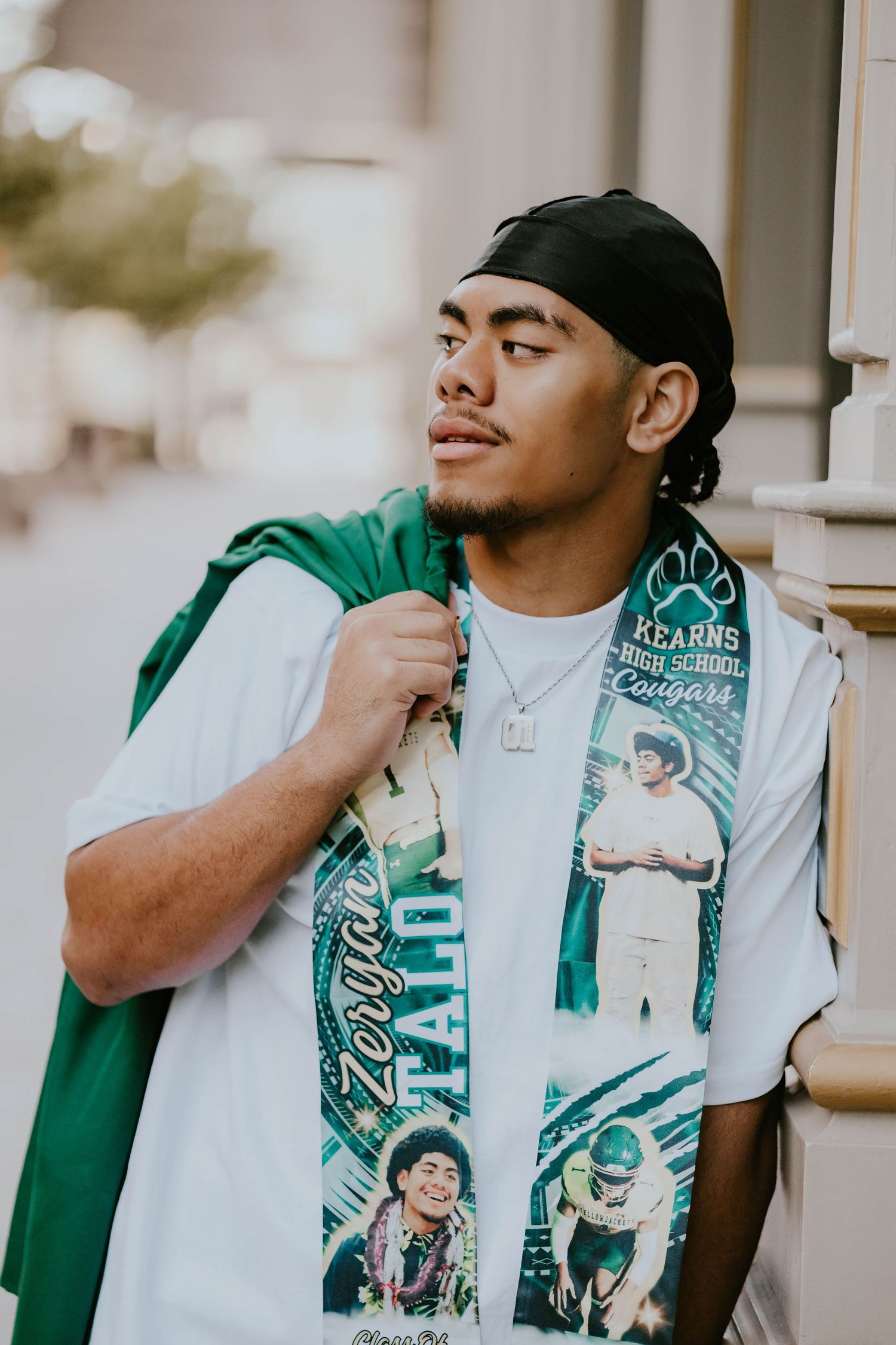 Person wearing green and white sports apparel posing in a casual photoshoot series.