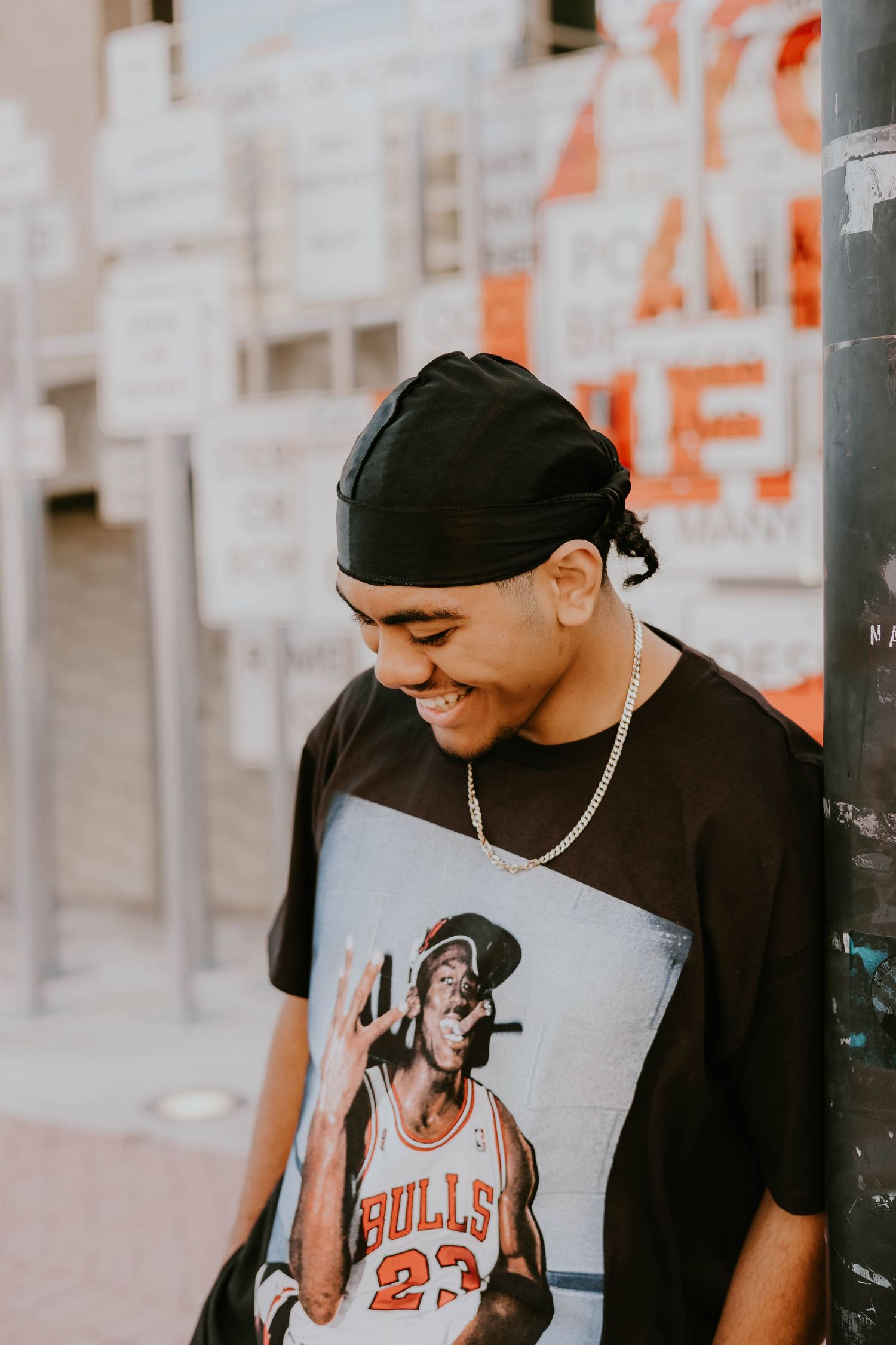 Casual portrait series showing person wearing Chicago Bulls t-shirt and baseball cap.