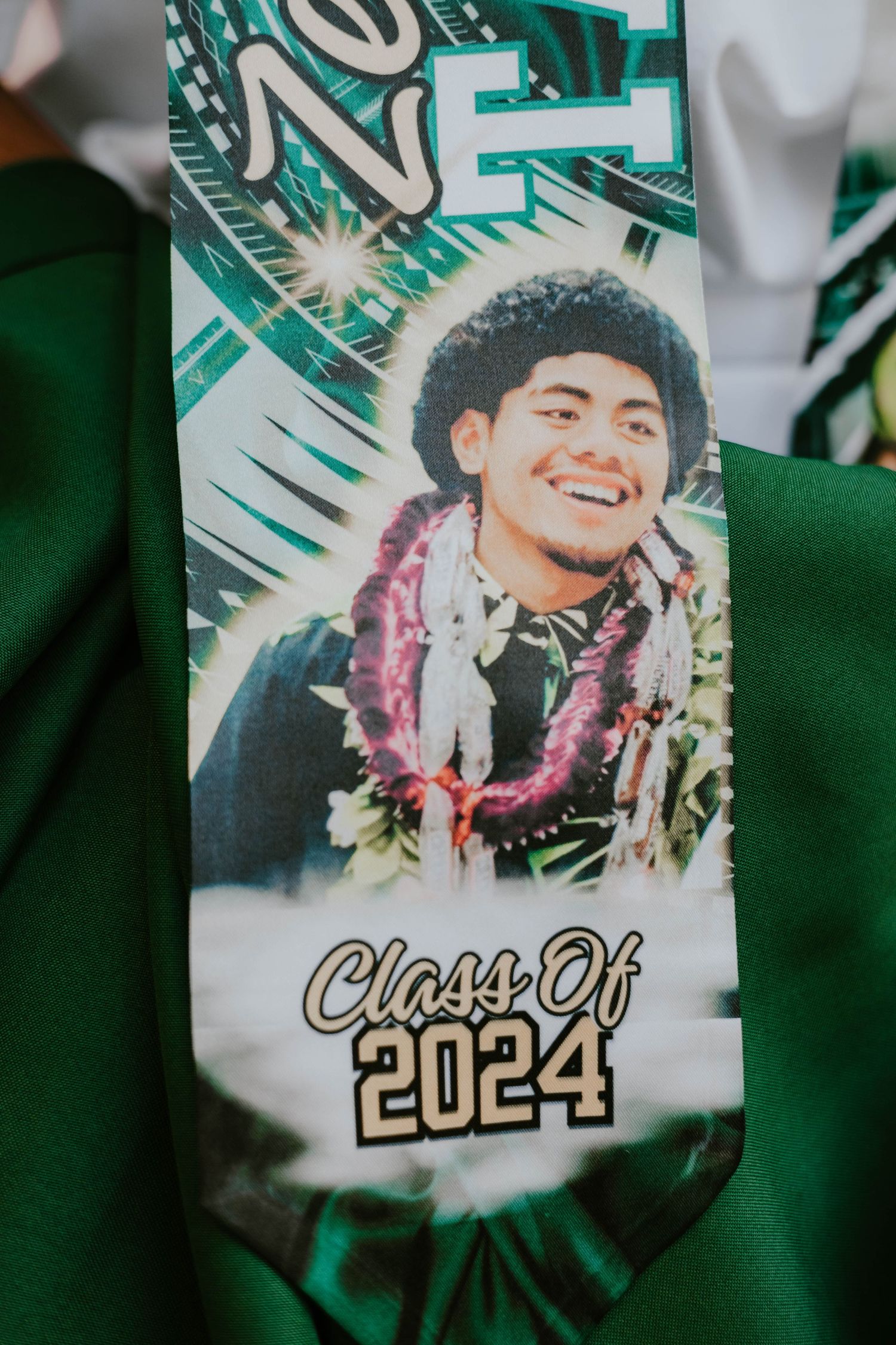 Close-up of green graduation memorabilia showing Class of 2024 text and decorative design.