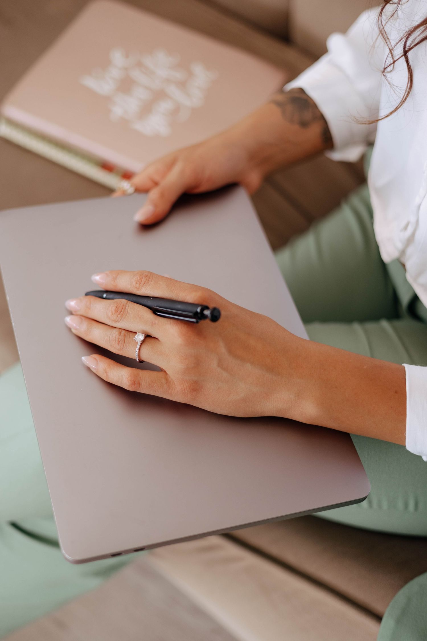 Hands working with papers and documents on a desk surface.