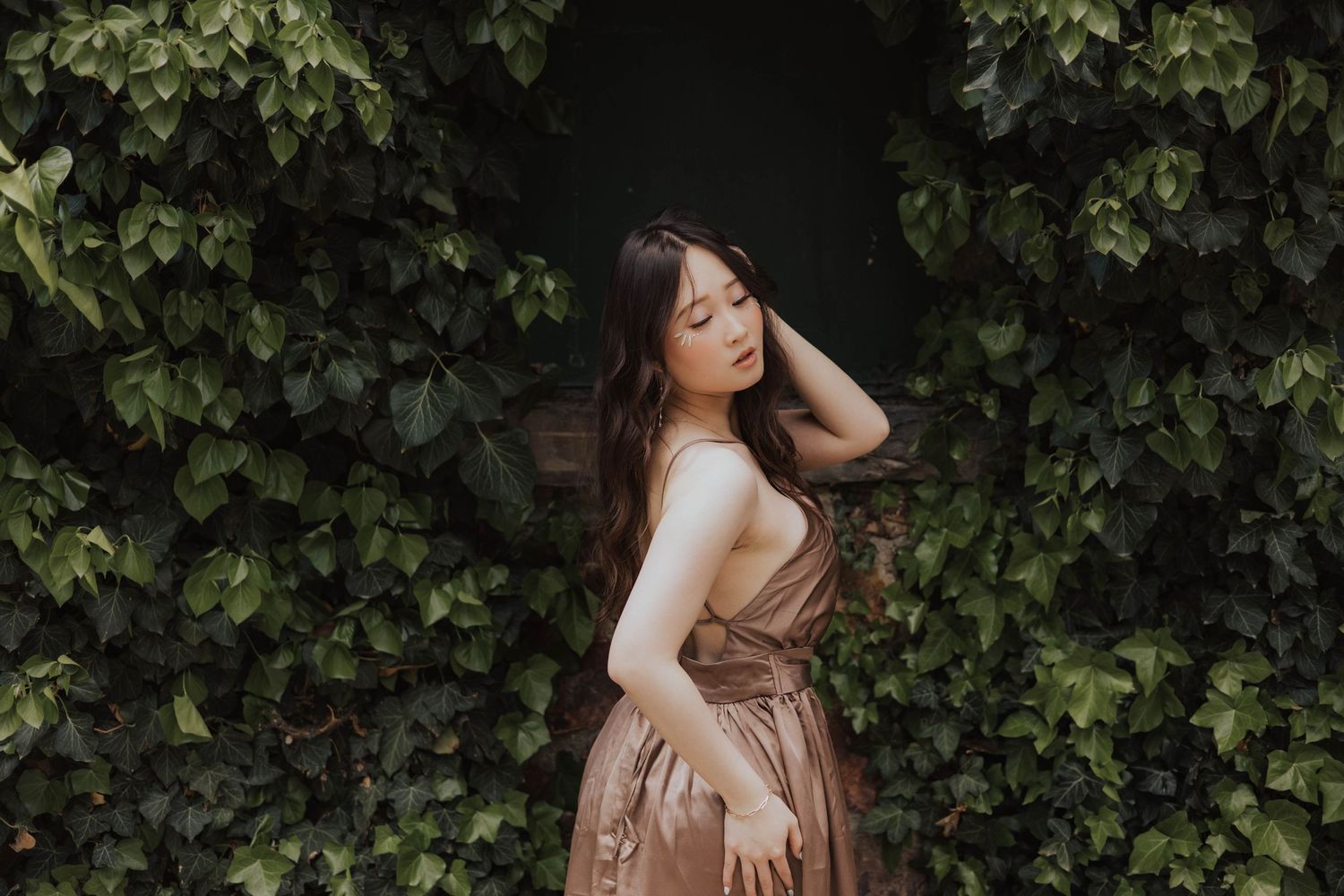 Artistic portrait series against lush green foliage background.