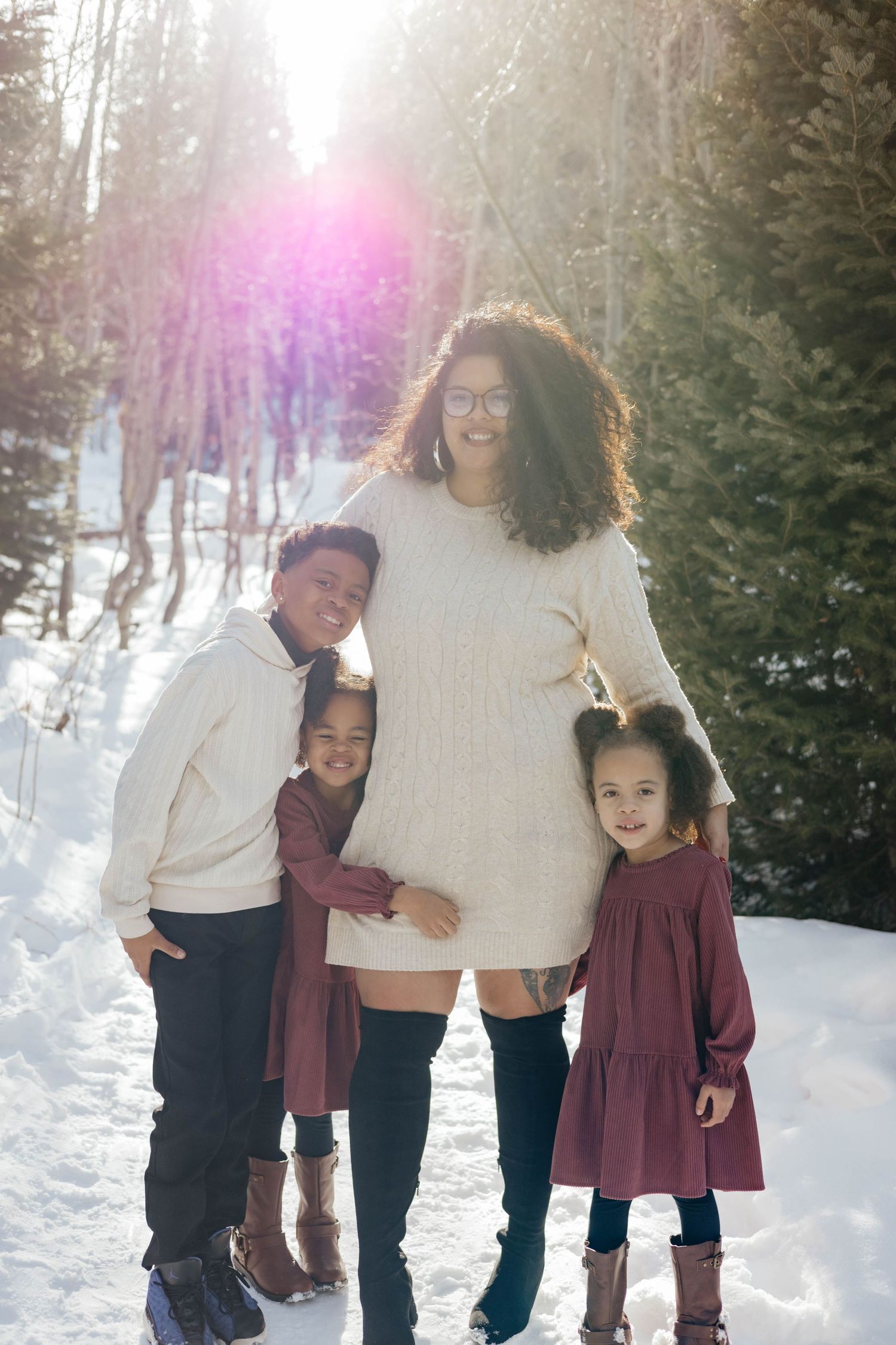 Family enjoying a winter day together in snowy mountain setting.