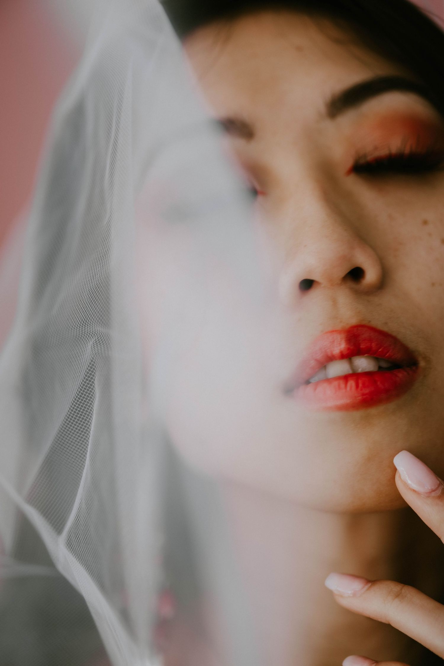 Close-up beauty shots showing bright red lipstick and soft lighting effects.