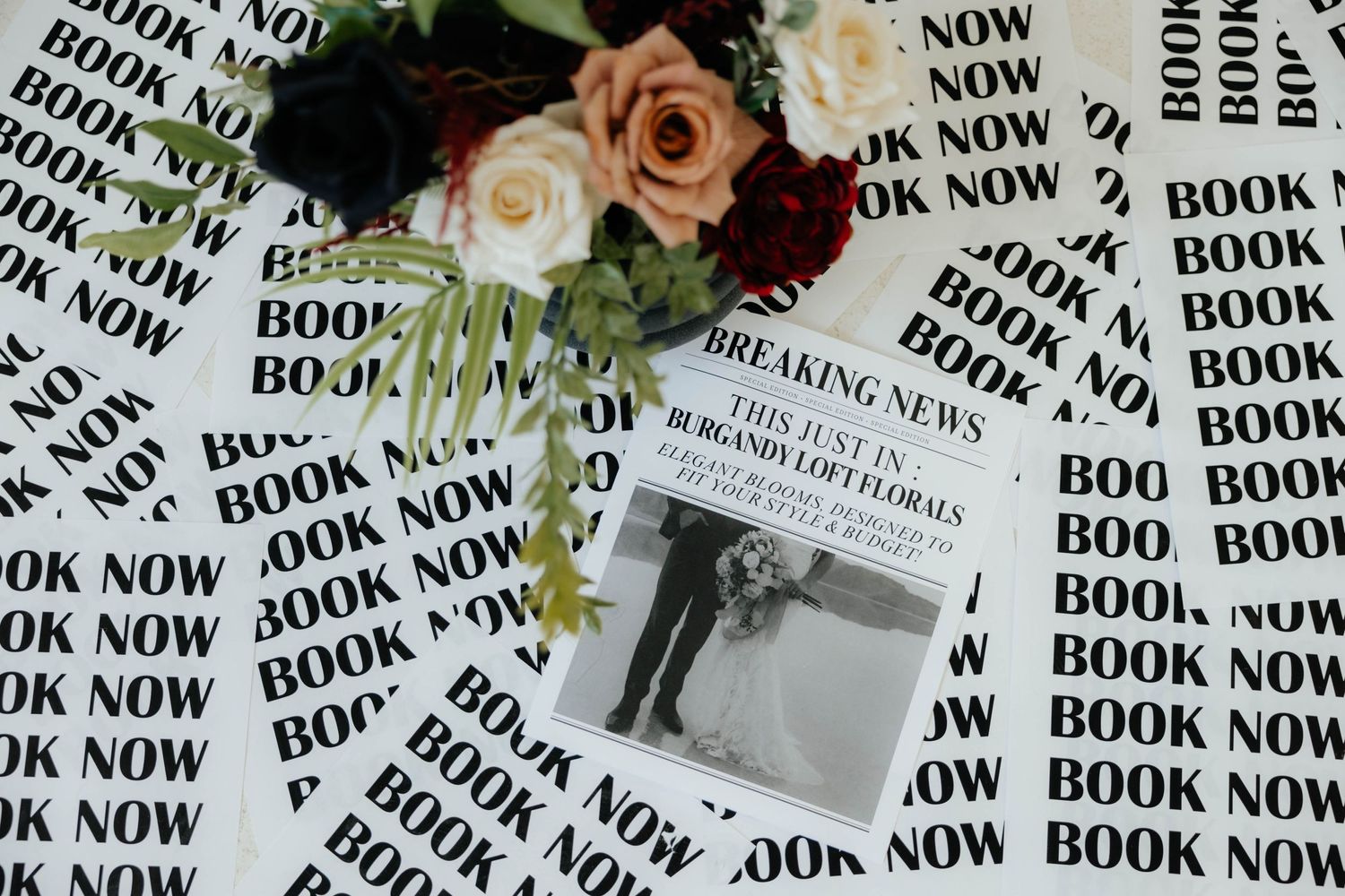 Decorative paper with repeating 'BOOK NOW' text pattern in black and white.