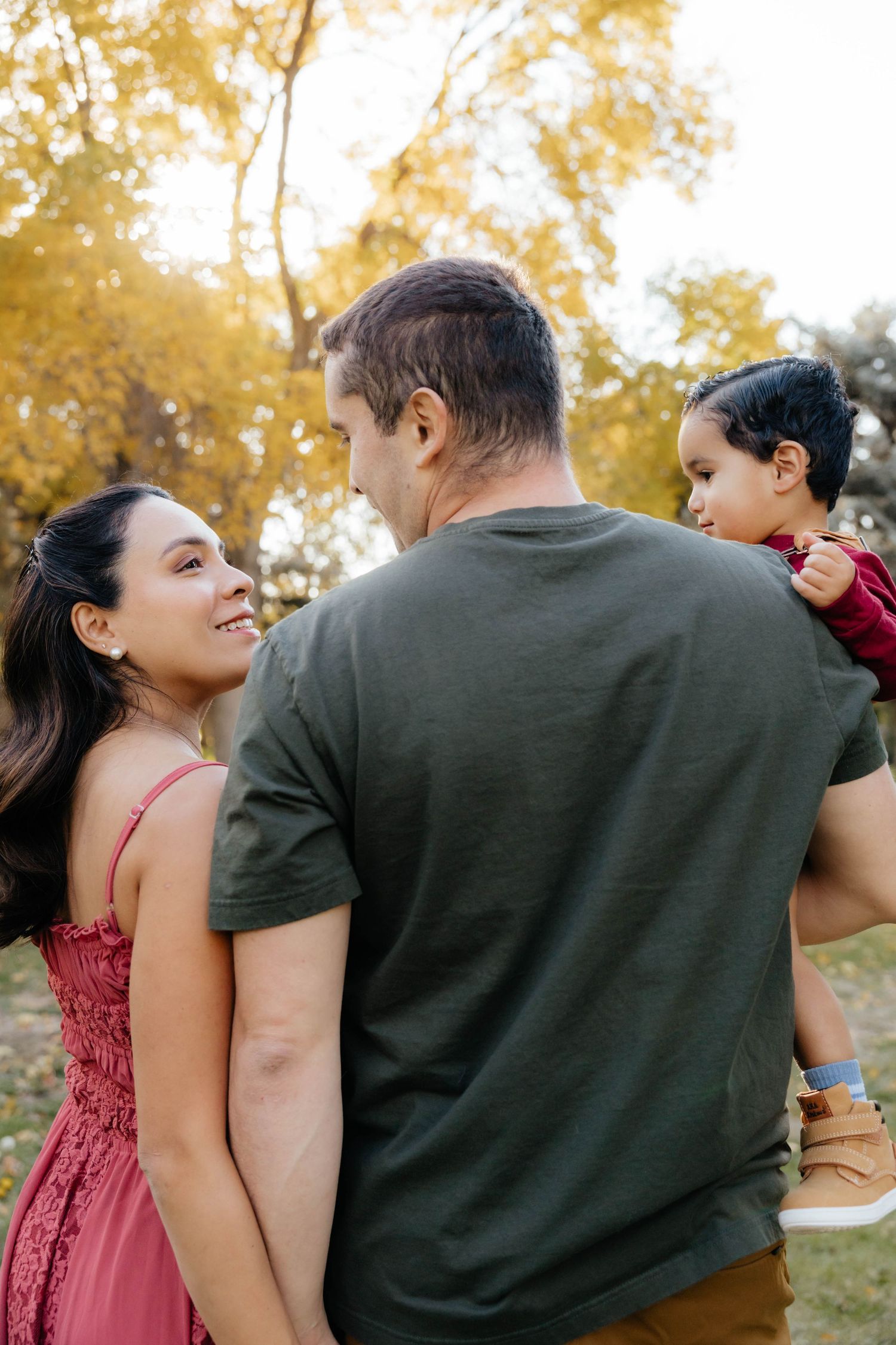 Couple shares joyful moments together in autumn park setting.