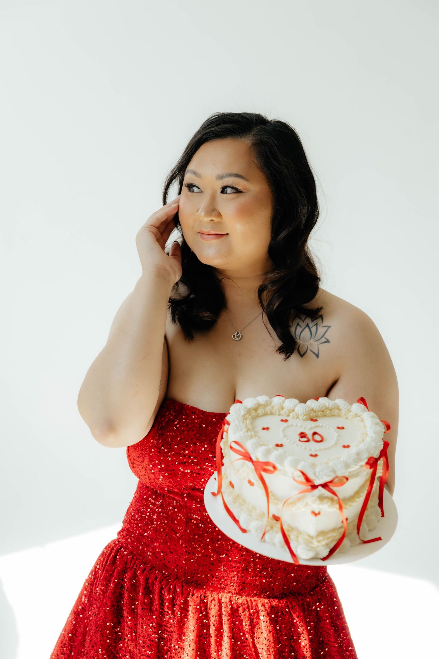 Elegant red sparkly dress photographed against a clean white studio backdrop.