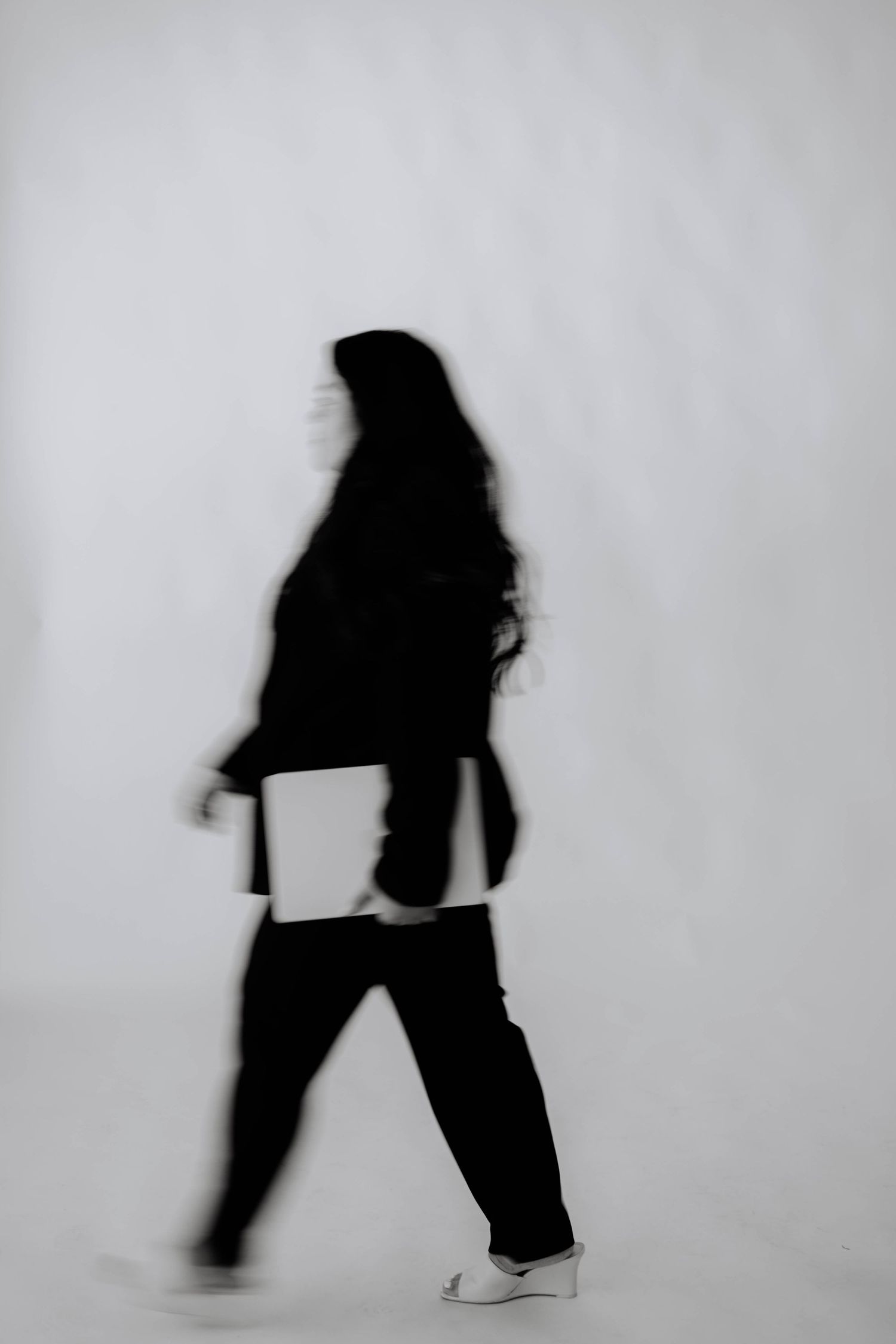 Silhouetted figure in motion against white background creating dynamic poses.