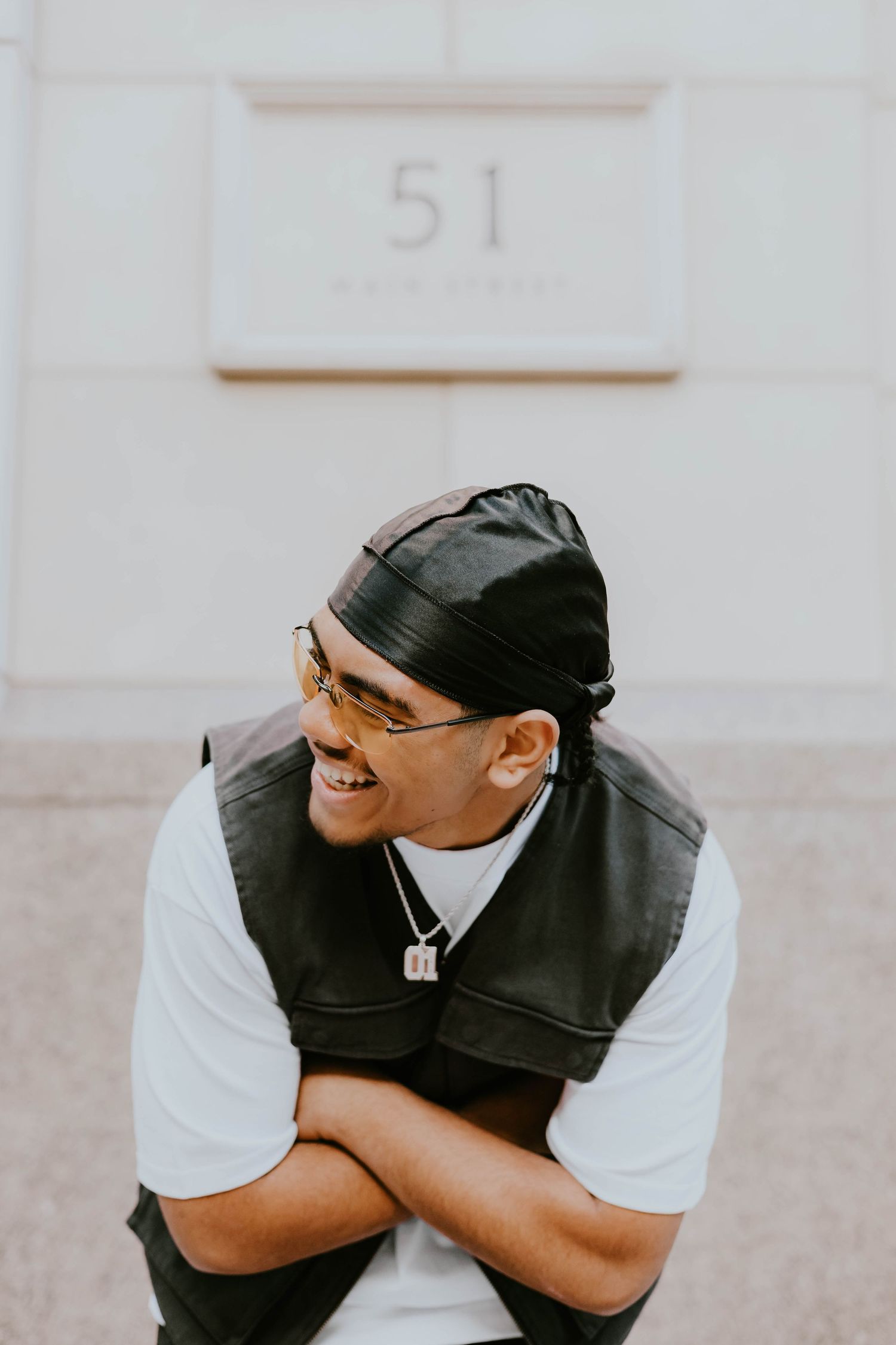 Urban fashion portraits featuring person in black vest and white t-shirt showing various expressions.