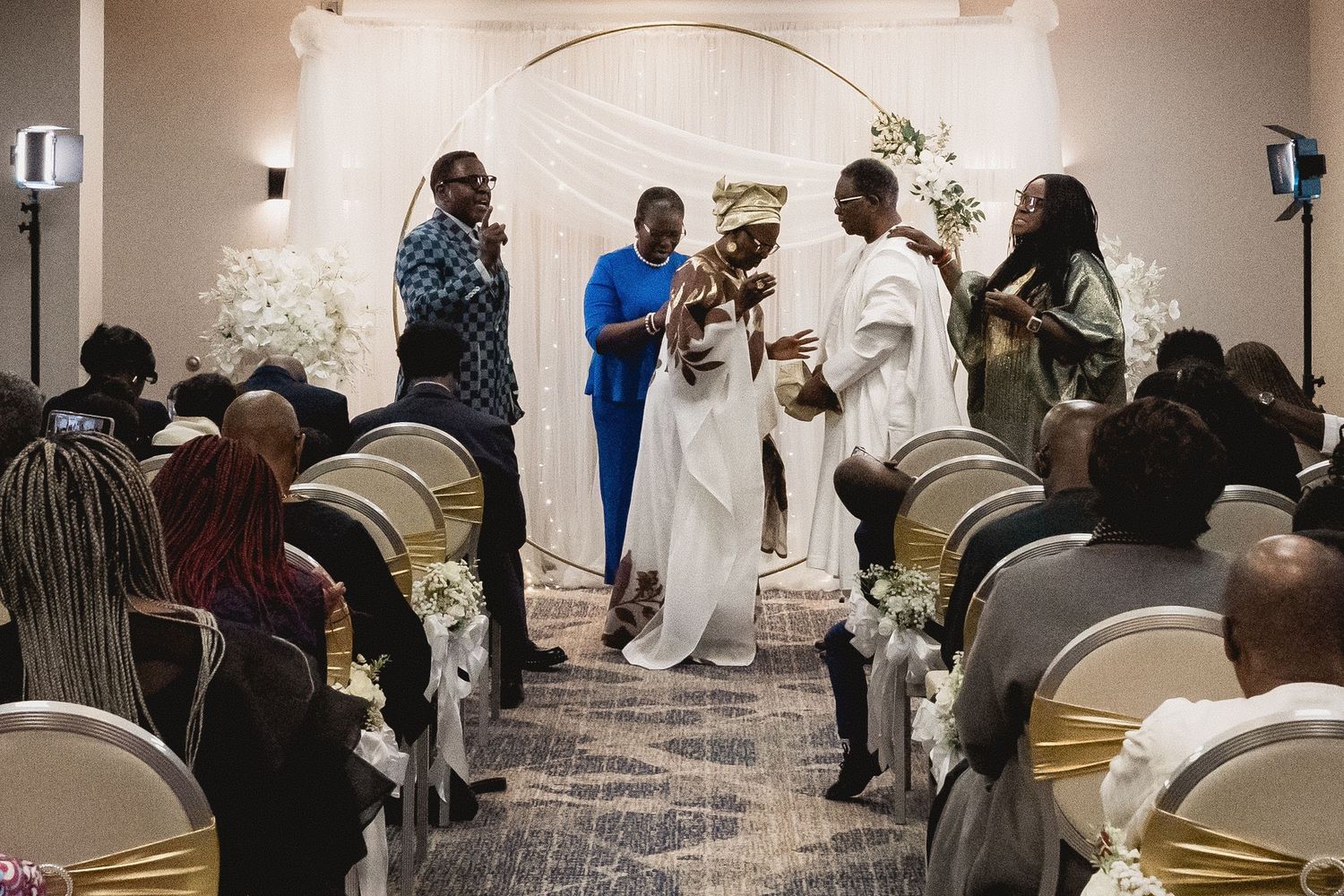 Wedding reception venue with elegant decor and guests enjoying the celebration.