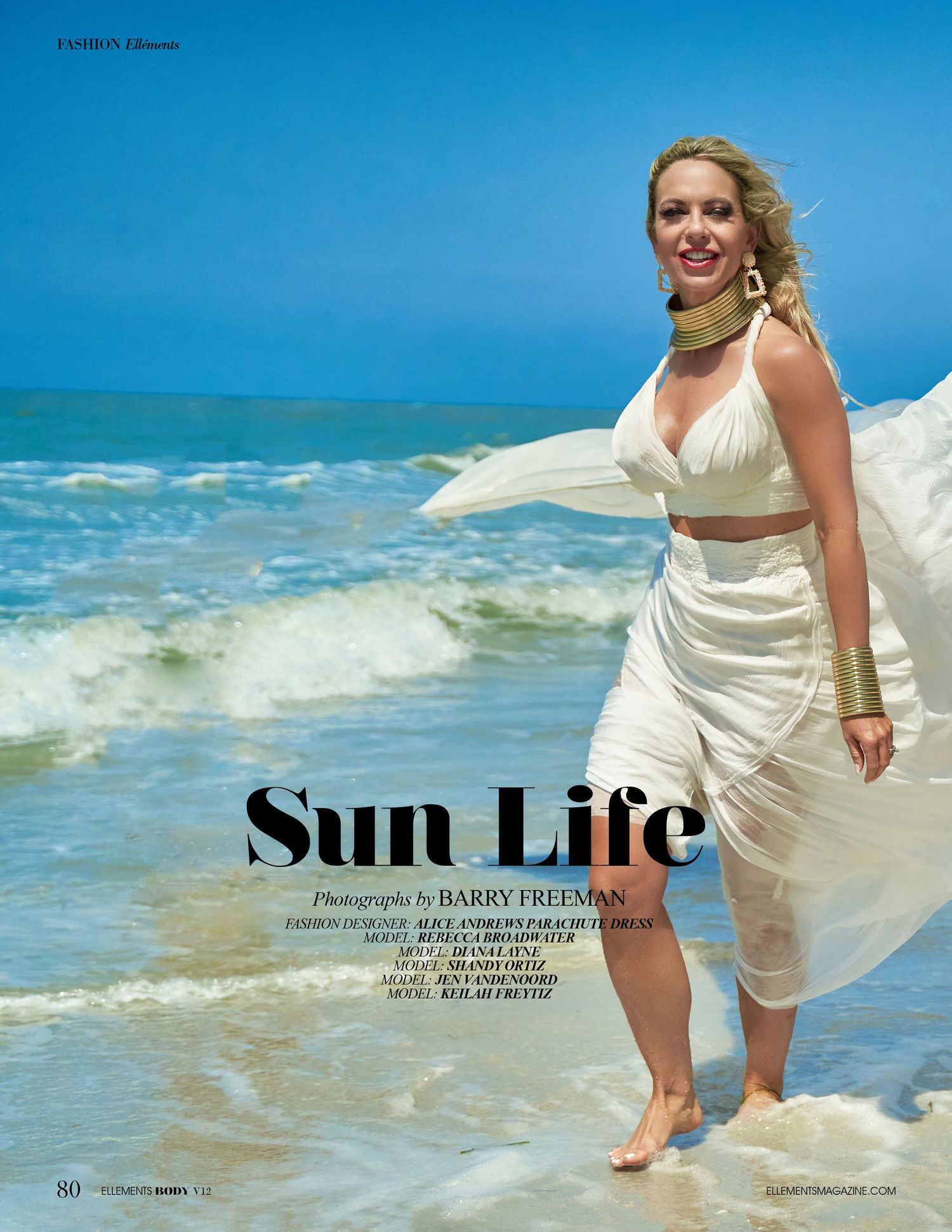 Beach fashion editorial featuring flowing white fabric against ocean waves.