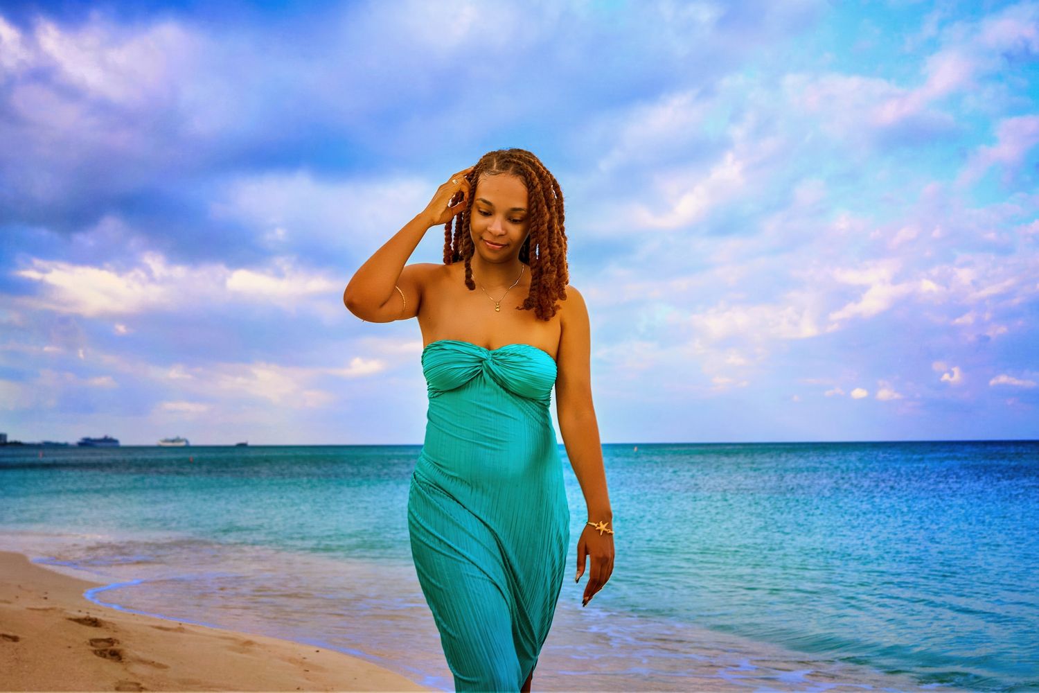Turquoise fabric flowing in the wind against tropical beach landscape.